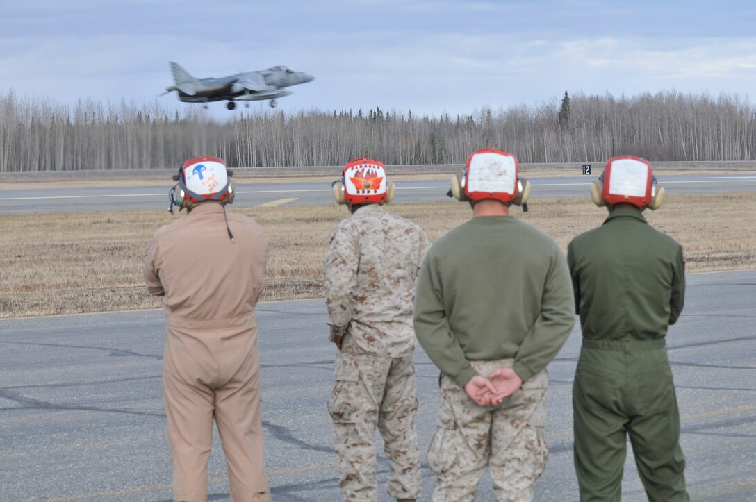 Marine Attack Squadron 211 ordnance technicians Cpl. Michael Wilkinson, left, Chief Warrant Officer 3 Jermaine Cadogan, Pfc. John Coram and Lance Cpl. Eric Perez watch as Maj. Michael Quinto, squadron executive officer, takes off on the flight line of Eielson Air Force Base, Alaska, April 20, 2010. The Yuma-based Marines returned home May 4, 2010, with approximately 165 other VMA-211 Marines after two-and-a-half weeks of aerial warfare training in Exercise Red Flag-Alaska, one of the largest joint-service exercises in the U.S. military.