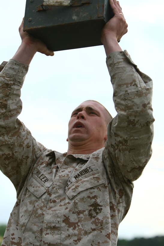 Sgt. Jensen Miller, a combat instructor with Company I, Marine Combat Training Battalion, School of Infantry-East, lifts an ammunition can above his head during the initial stage of the MCT Battalion Combat Instructor Competition aboard Camp Geiger, N.C., April 21.  Five companies chose their top five combat instructors to compete in the two-day event that tested common skills and gave the winning team bragging rights within the spirit of competition.