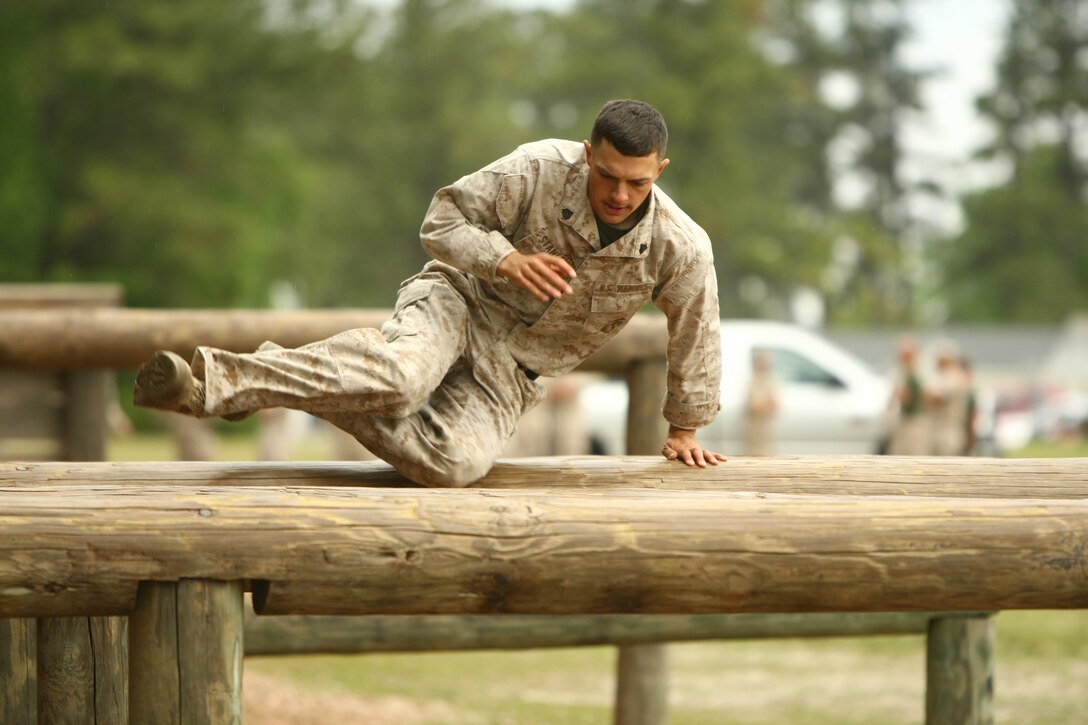 Sgt. Richard Stanley, a combat instructor with Company G, Marine Combat Training Battalion, School of Infantry-East, jumps over high logs during the obstacle course portion of the MCT Battalion Combat Instructor Competition aboard Camp Geiger, N.C., April 21.  The 25 combat instructors ran the O-course right after finishing a one-mile stretcher run and right before a three-mile hike with heavy equipment to Camp Devil Dog.