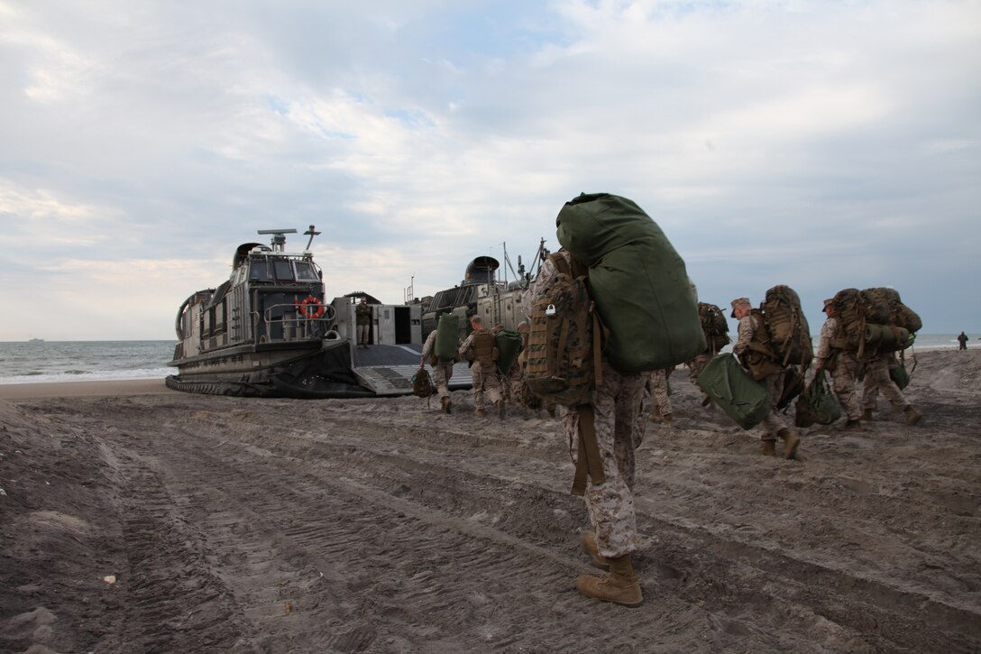 Marines from Battalion Landing Team 3/8, 26th Marine Expeditionary Unit, board a Landing Craft Air Cushioned (LCAC) on Onslow Beach, Camp Lejeune, NC, April 21, 2010. The LCACs transported Marines and equipment from BLT 3/8 onto USS Kearsarge. Marines from 26th MEU will be introduced to life aboard the ships and are conducting an Amphibious Squadron (PHIBRON) MEU Integration Training (PMINT) exercise aboard USS Kearsarge, USS New York, and USS Carter Hall.