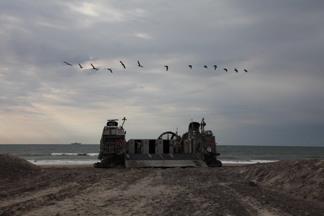 Landing Craft Air Cushioned (LCAC) 27 waits on Onslow Beach, Camp Lejeune, NC, April 21, 2010. The LCACs transported Marines and equipment from Battalion Landing Team 3/8 onto USS Kearsarge. Marines from 26th Marine Expeditionary Unit will be introduced to life aboard the ships and are conducting an Amphibious Squadron (PHIBRON) MEU Integration Training (PMINT) exercise aboard USS Kearsarge, USS New York, and USS Carter Hall.