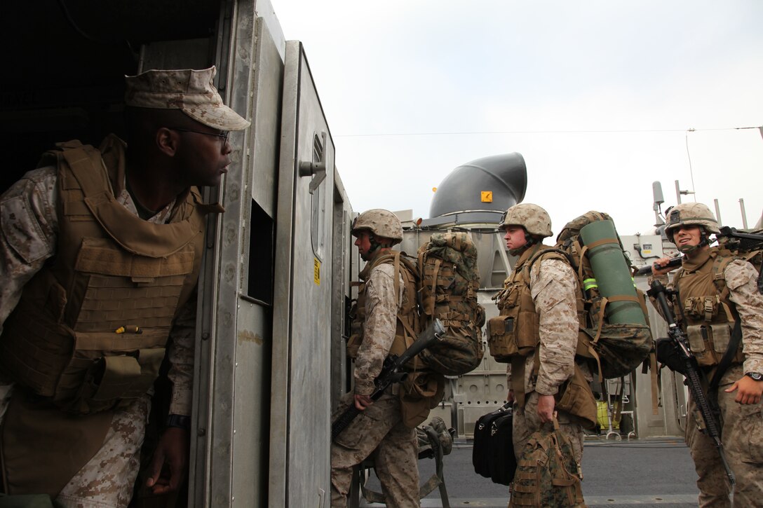 Gunnery Sgt. Jason L. Smith, Combat Engineer, Battalion Landing Team 3/8, 26th Marine Expeditionary Unit, watches as Marines from BLT 3/8 board a Landing Craft Air Cushioned (LCAC) on Onslow Beach, Camp Lejeune, NC, April 21, 2010. The LCACs transported the Marines and their equipment onto USS Kearsarge. Marines from 26th MEU will be introduced to life aboard the ships and are conducting an Amphibious Squadron (PHIBRON) MEU Integration Training (PMINT) exercise aboard USS Kearsarge, USS New York, and USS Carter Hall.