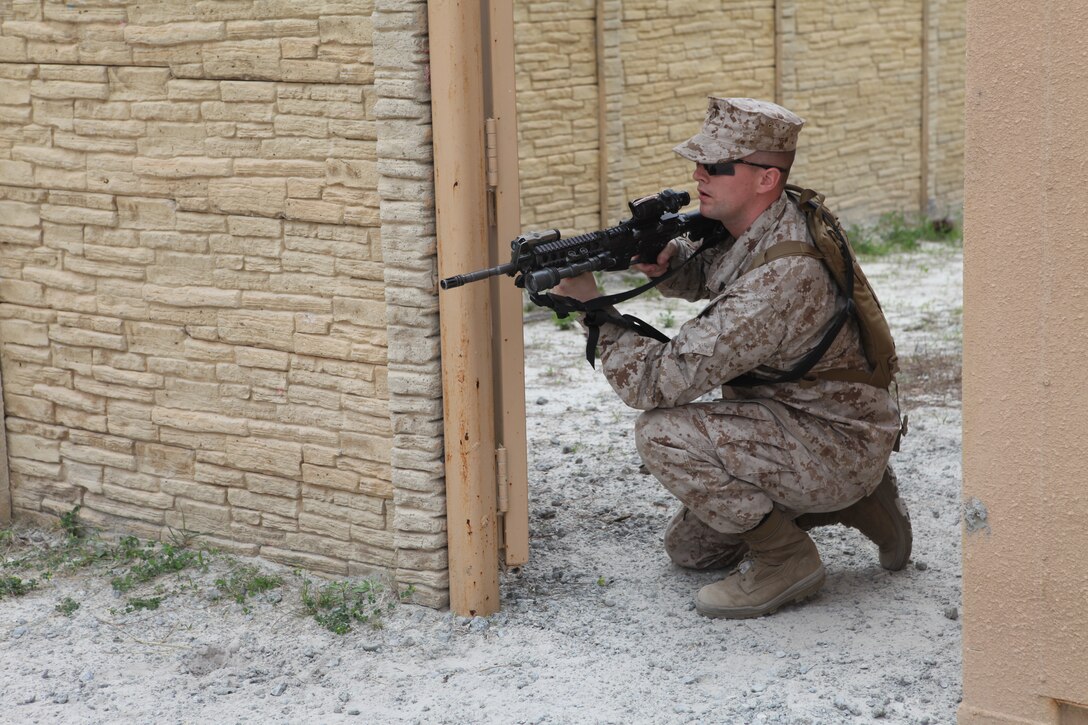Corporal Gabriel Brown with Company K, Battalion Landing Team 3/8, 26th Marine Expeditionary Unit, practices providing security during a patrol through Combat Town during the Motorized Raid Course aboard Camp Lejeune, N.C., April 21, 2010. The Motorized Raid Course is one of several Special Operations Training Group, II Marine Expeditionary Force, events as part of 26th MEU's preparation for deployment this fall.