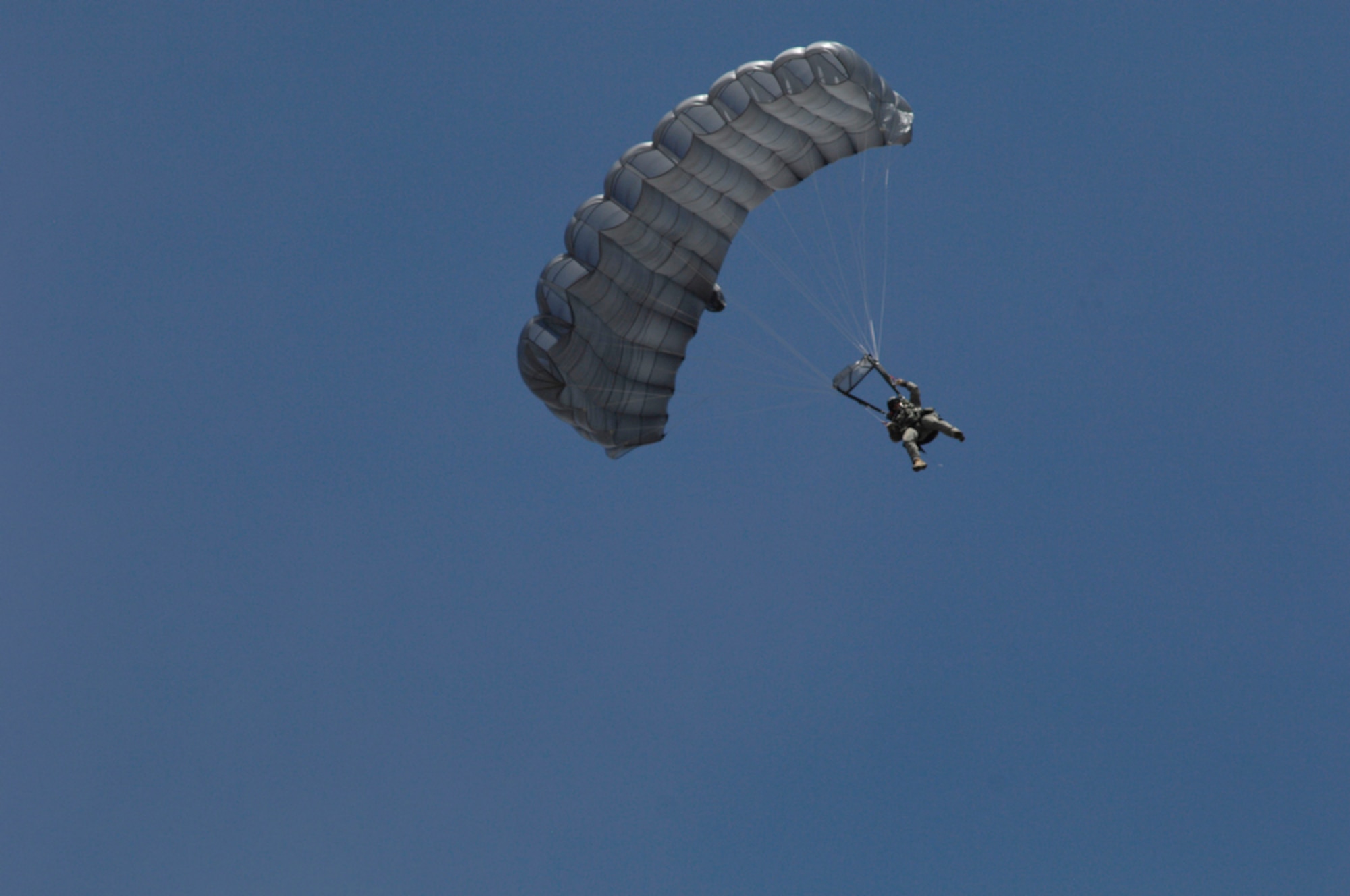 An Indonesian soldier glides to the ground after jumping from a C-130 Hercules April 21, 2010, during Cope West 10 at Halim Air Base, Indonesia.  Cope West is a Pacific Air Forces-sponsored bilateral tactical airlift exercise involving the U.S. and Indonesian air forces. The exercise is designed to advance interoperability between the two services, and promote cooperation and unity of purpose. (U.S. Air Force photo/Tech Sgt. Cohen A. Young)