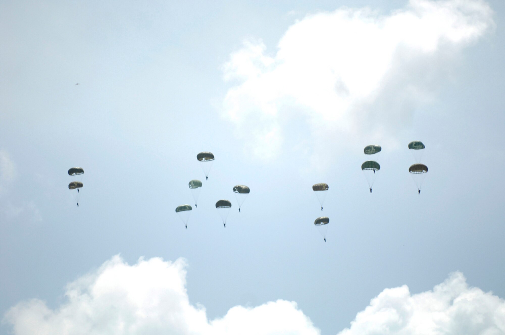 Indonesian soldiers and airmen jump from an Indonesian C-130 Hercules April 21, 2010, during Cope West 10 at Halim Air Base, Indonesia.  Cope West is a Pacific Air Forces-sponsored bilateral tactical airlift exercise involving the U.S. and Indonesian air forces. The exercise is designed to advance interoperability between the two services, and promote cooperation and unity of purpose. (U.S. Air Force photo/Tech Sgt. Cohen A. Young)