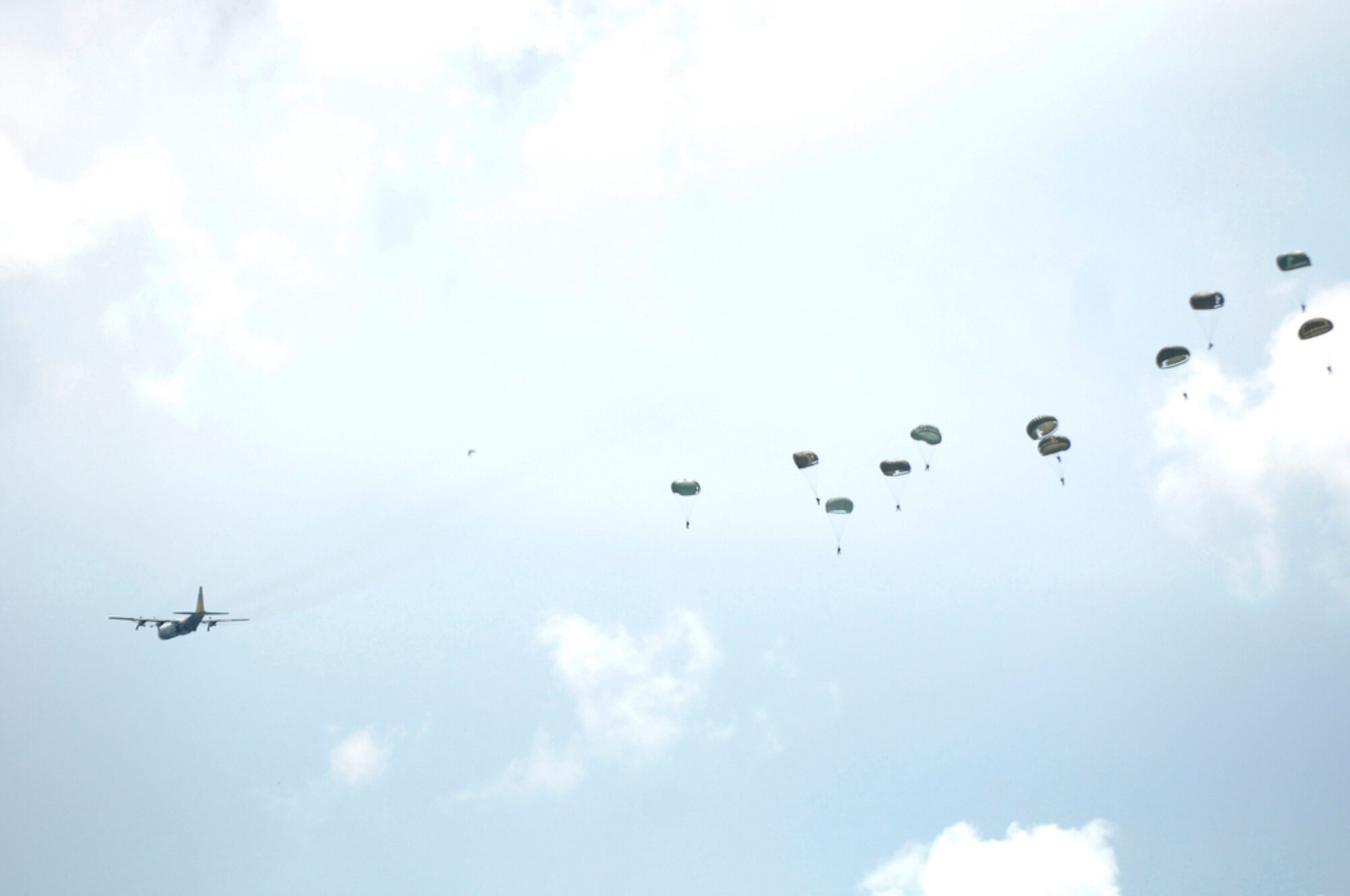 Indonesian soldiers and airmen jump from an Indonesian C-130 Hercules April 21, 2010, during Cope West 10 at Halim Air Base, Indonesia.  Cope West is a Pacific Air Forces-sponsored bilateral tactical airlift exercise involving the U.S. and Indonesian air forces. The exercise is designed to advance interoperability between the two services, and promote cooperation and unity of purpose. (U.S. Air Force photo/Tech Sgt. Cohen A. Young)