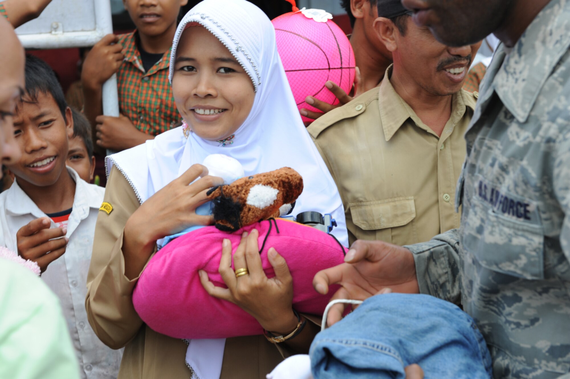 An Indonesian teacher from the Sd Negeri Gembor 2 Elementary School in Lanud Gorda Binuang, Indonesia, smiles April 21, 2010, after receiving more than 1,200 pounds of clothes, toys and sports equipment from Yokota Air Base, Japan.  Yokota Airmen are participating in Cope West 10, a Pacific Air Forces-sponsored bilateral tactical airlift exercise involving the U.S. and Indonesian air forces. The exercise is designed to advance interoperability between the two services, and promote cooperation and unity of purpose. (U.S. Air Force photo/Tech Sgt. Cohen A. Young)