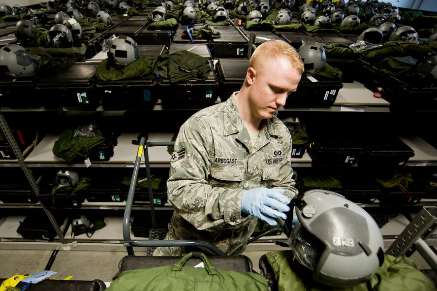 Senior Airman Dustin Aborgast, 62nd Operations Support Squadron, retrieves an aircrew helmet from a storage location at the 62nd OSS Aircrew Flight Equipment section April 21. The flight is responsible for maintaining approximately 1,000 helmet and chemical warfare ensemble kits for active duty and reserve aircrew. (U.S. Air Force Photo by Abner Guzman)