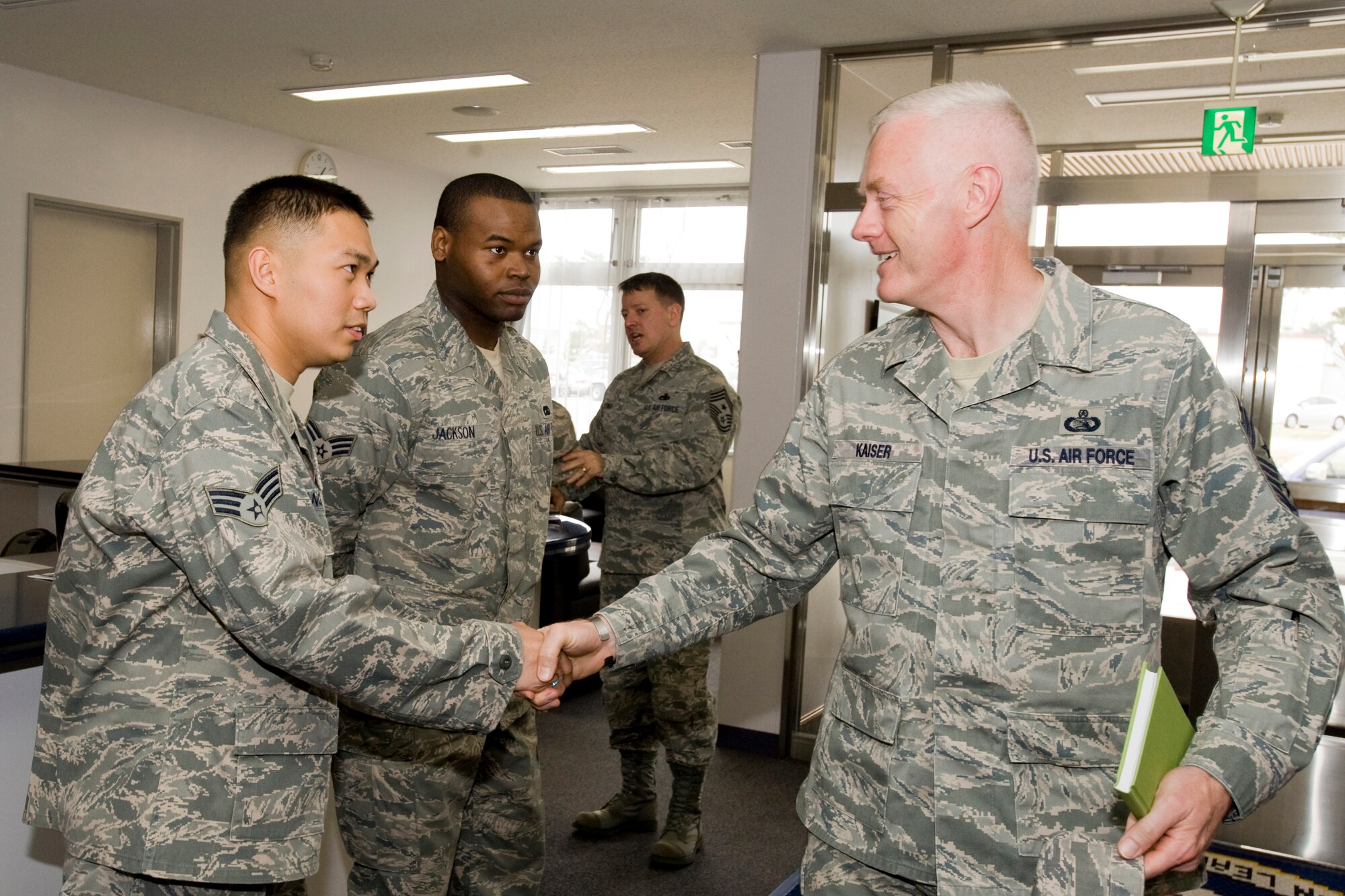MISAWA AIR BASE, Japan -- Chief Master Sgt. Richard Kaiser, 5th Air Force command chief master sergeant, greets Airman Leadership School class 10-D students Senior Airmen Donald Jackson and Leo Mangahas April 20 at the ALS facility. The ALS class was only in their second day of training when Chief Kaiser stopped by to meet them, talk and answer questions. (U.S. Air Force photo/Senior Airman Jamal D. Sutter)