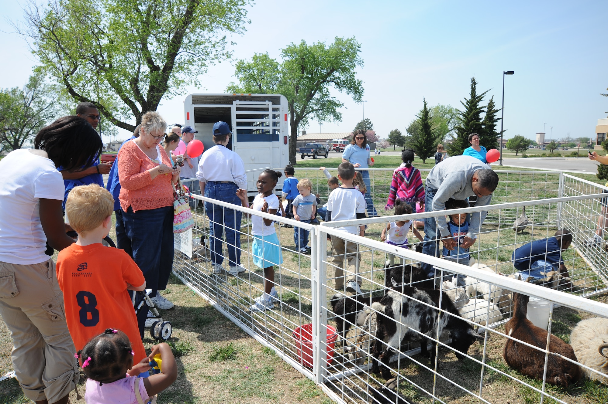 Team McConnell members pet animals at the Family Festival of Fun, April 17, 2010, McConnell Air Force Base, Kan. More than 3,000 Team McConnell members participated in activities such as inflatables, crafts, games, petting zoo and live entertainment during the festival. The festival celebrated the military children at McConnell. The event was part of the Air Force-designated Month of the Military Child. McConnell use the festival to recognize the 2,100 children who are dependents of military members here. (U.S. Air Force photo/Tech. Sgt. Chyrece Campbell)