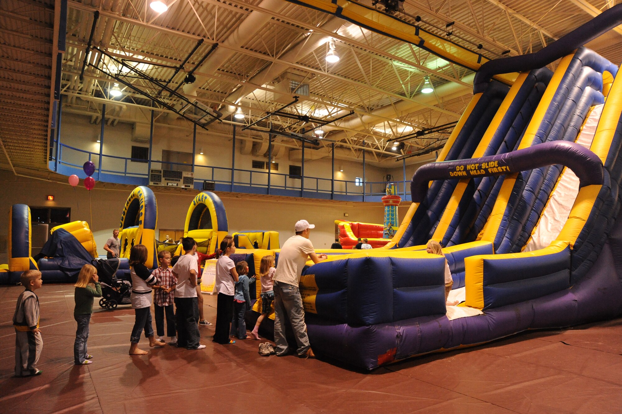 Team McConnell members wait in line for the inflatables during the Family Festival of Fun, April 17, 2010, McConnell Air Force Base, Kan. The festival coincided with Month of the Military Child, an Air Force-designated month dedicated to thank the military’s youngest supporters. (U.S. Air Force photo/Tech. Sgt. Chyrece Campbell)