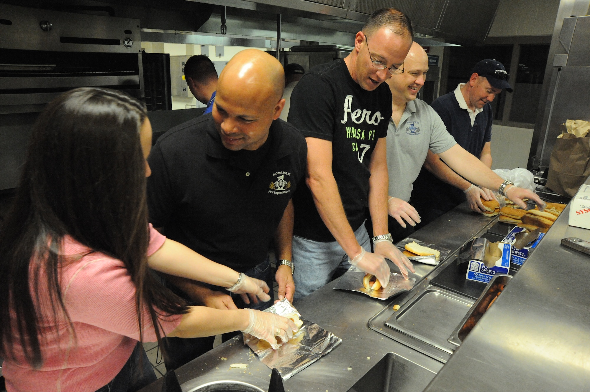 Members from McConnell’s First Sergeants Council prepare hot dogs at the Family Festival of Fun , April 17, 2010, McConnell Air Force Base, Kan. More than 3,000 Team McConnell members participated in activities including inflatables, crafts, games, petting zoo, car seat safety check and live entertainment. As first sergeants, these men and women, are directly responsible for the welfare, morale and conduct of all the enlisted members in their assigned squadrons. (U.S. Air Force photo/Tech. Sgt. Chyrece Campbell)