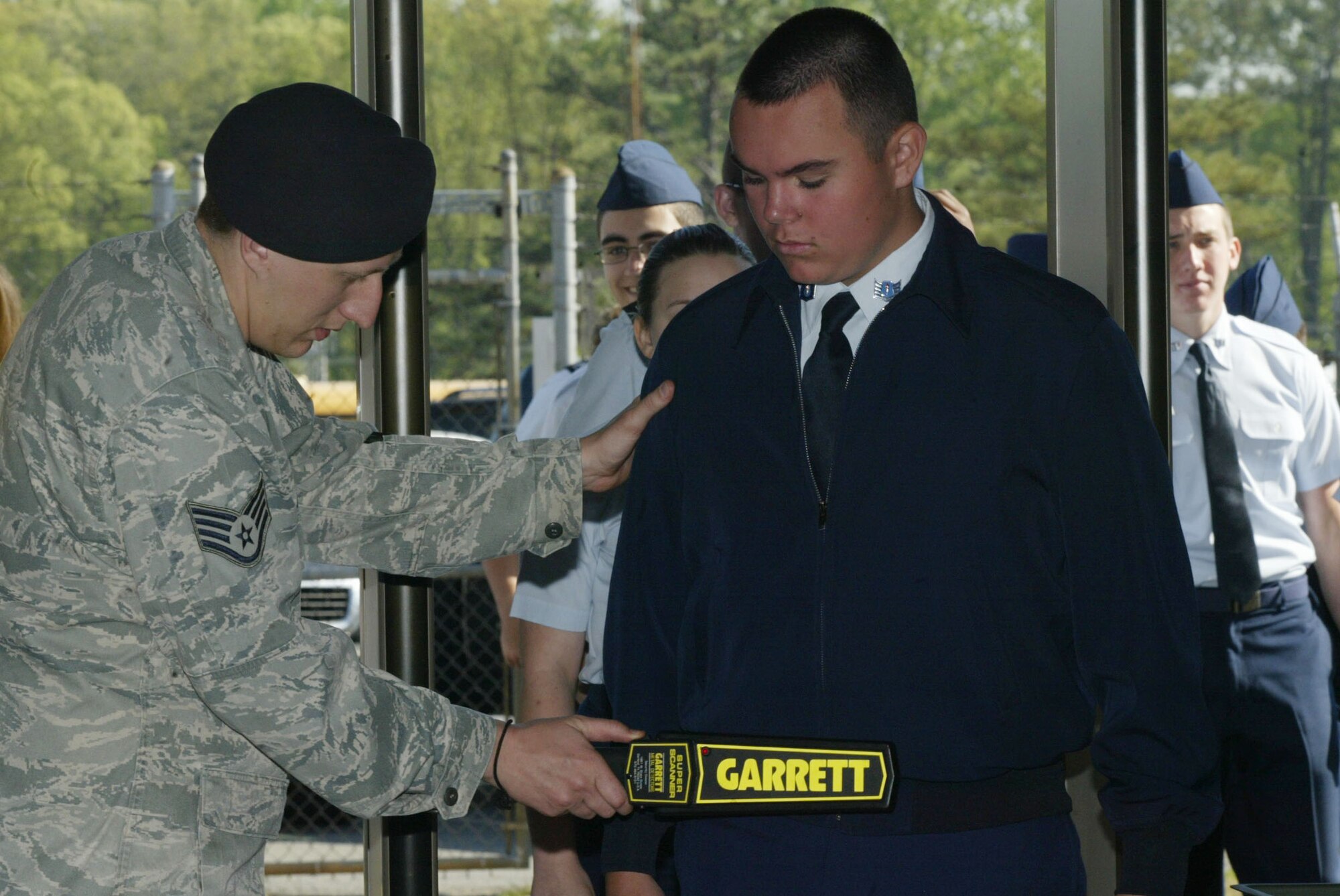 Cadets entering staging area pass through a security screening area conducted by members of the 94th Security Forces Squadron April 13-14. Orientation flights are designed to introduce youth to general aviation and military opportunities through hands-on interaction with aircraft, equipment and personnel. (U.S. Air Force photo/Don Peek)
