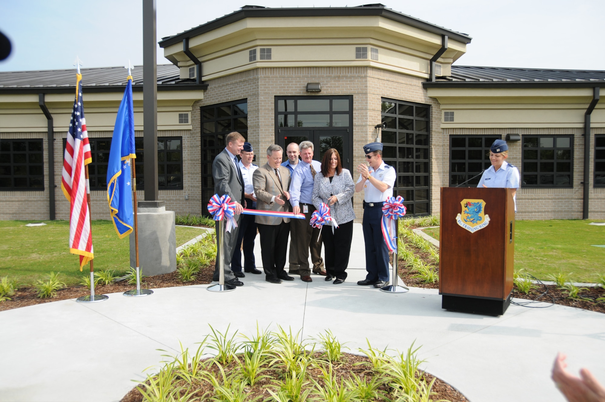 Participants in the Monday's ribbon-cutting ceremony for Keesler’s new postal service center are (from left) John McKinley, 81st Communications Squadron director; Col. Jeffrey Jackson, 81st Mission Support Group commander; William Yates, president of Yates Construction Co.; Matthew Hamlett and Michelle Vandermeer, 81st CS project managers; Col. Chris Valle, 81st Training Wing vice commander and Capt. Cieara Carson, 81st CS, emcee. The $3.3 million facility on Meadows Drive replaces a wooden structure built in 1941 that had termite problems and major flood and roof damage from Hurricane Katrina.  (U.S. Air Force photo by Kemberly Groue)