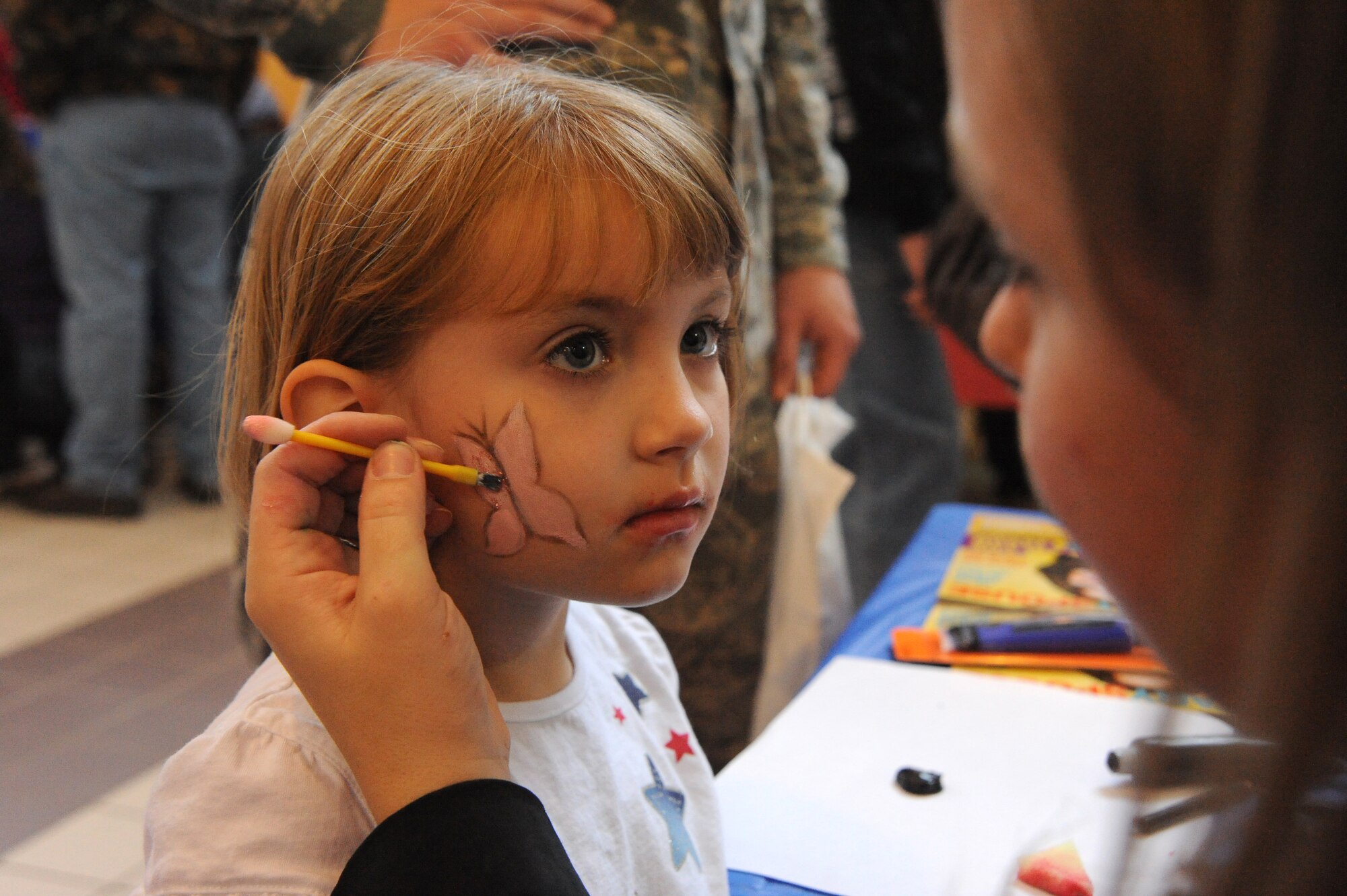 Amy Jensen, 22nd Force Support Squadron Social Services Assistant, draws a butterfly on Kendal Golleher, 4-year-old Team McConnell family member, at the Family Festival of Fun face painting station, April 17, 2010, McConnell Air Force Base, Kan. More than 3,000 Team McConnell members attended the event. The 22nd FSS provides services to more than 16,460 military and civilian Team McConnell members. (U.S. Air Force photo/Tech. Sgt. Chyrece Campbell)