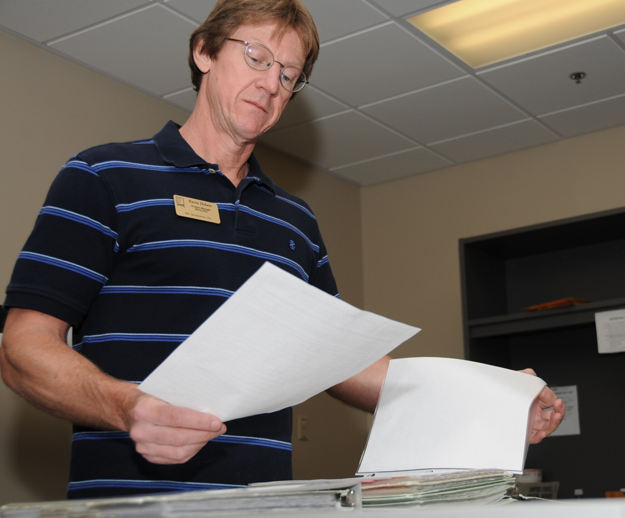 Kevin Hebert, project manager for the official mail center and postal service center, files forms Monday.  (U.S. Air Force photo by Kemberly Groue)