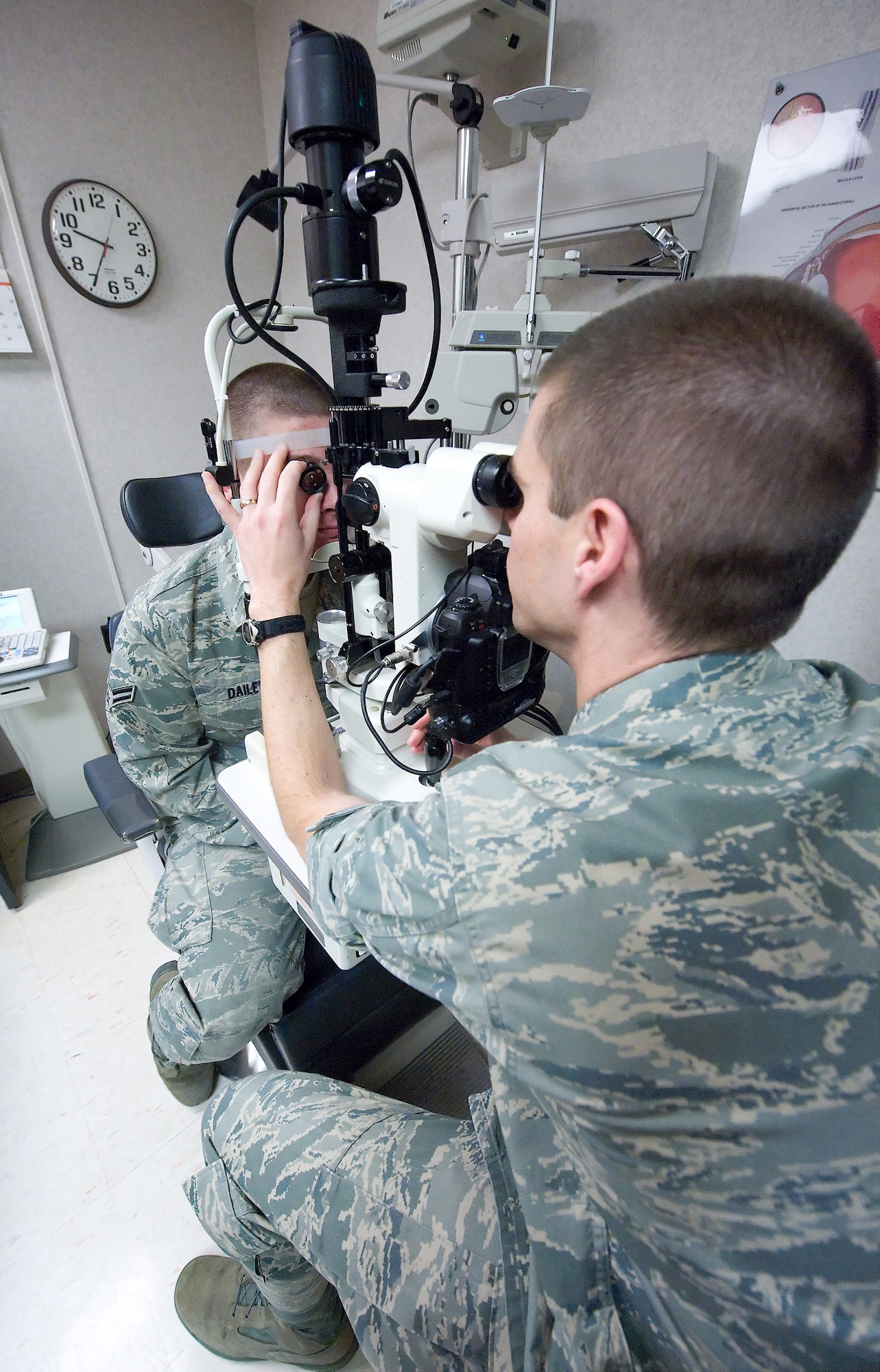 (Right) Capt. Jeffrey Newsom, 436th Aerospace Medicine Squadron Optometry Flight commander, uses at slit-lamp microscope to examine the inside of Airman 1st Class O'Ryan Dailey's, 436th Maintenance Squadron maintenance fabrication technician, eye during a general check-up April 21. This device is one of many used by the Optometry clinic to facilitate eye health. (U.S. Air Force photo/Brianne Zimny)