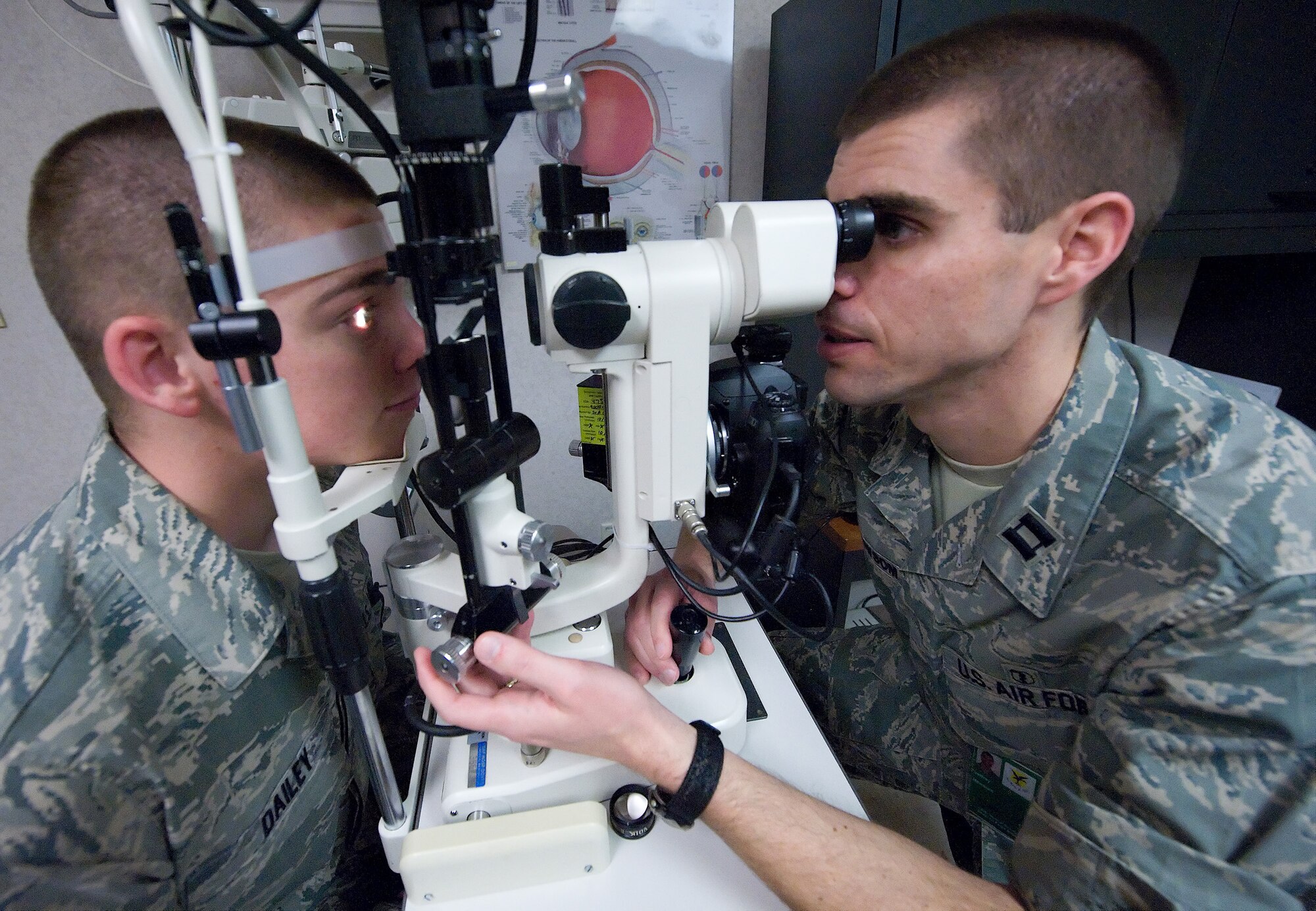 (Right) Capt. Jeffrey Newsom, 436th Aerospace Medicine Squadron Optometry Flight commander, uses at slit-lamp microscope to examine the outside of Airman 1st Class O'Ryan Dailey's, 436th Maintenance Squadron maintenance fabrication technician, eye during a general check-up April 21. This procedure is a common practice at the Optometry clinic. (U.S. Air Force photo/Brianne Zimny)