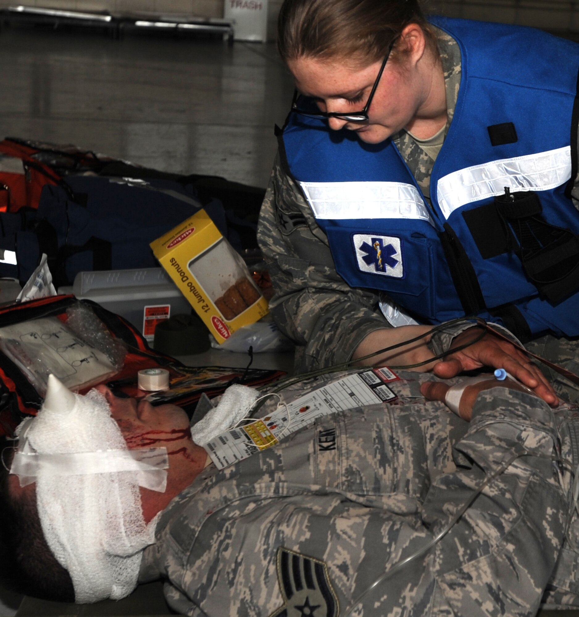 Airman 1st Class Carol Hubbard, 319th Medical Group, checks a “patient’s” pulse during a Major Accident Response Exercise April 20 at Grand Forks Air Force Base, N.D. The MARE was designed to test the base’s ability to respond to a major incident and is just one of the ways the base is preparing for its upcoming Air Show. (U.S. Air Force photo by Staff Sgt. Suellyn Nuckolls)