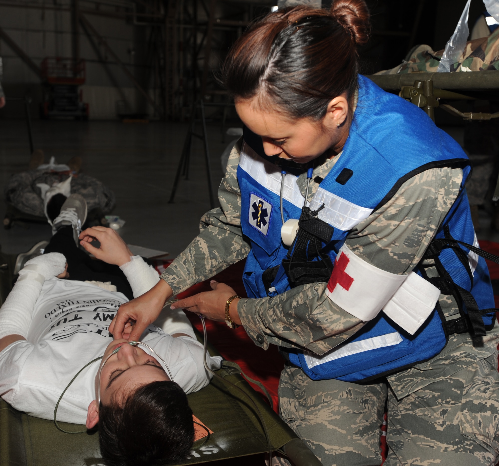 An Airman with the 319th Medical Group monitors a “patient’s” breathing during a Major Accident Response Exercise April 20 at Grand Forks Air Force Base, N.D. The MARE was designed to test the base’s ability to respond to a major incident and is just one of the ways the base is preparing for its upcoming Air Show. (U.S. Air Force photo by Staff Sgt. Suellyn Nuckolls)