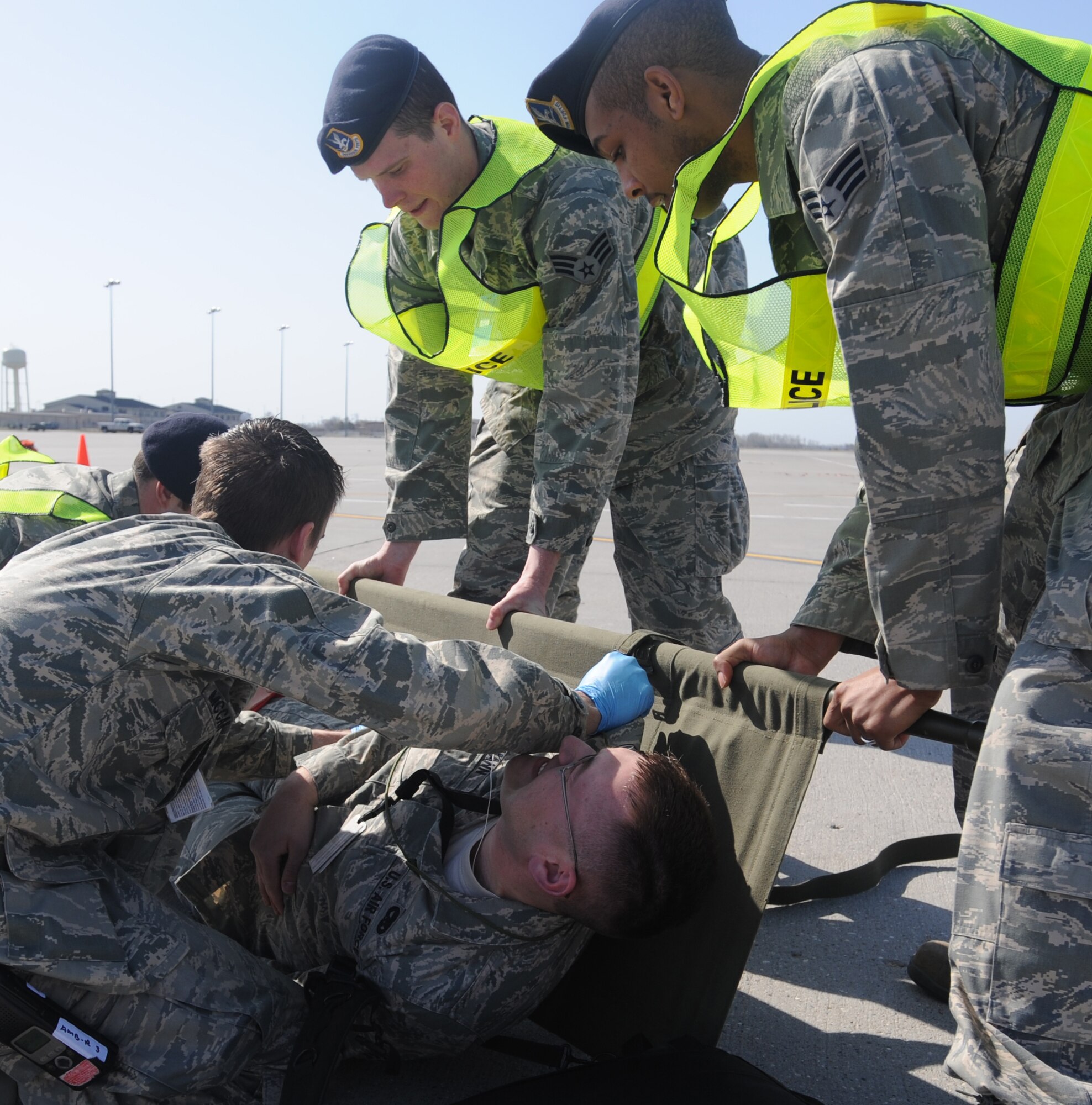 Airmen from the 319th Security Forces Squadron and an Airman from the 319th Medical Group, prepare to transport an “injured” Airman during a Major Accident Response Exercise April 20 at Grand Forks Air Force Base, N.D. The MARE was designed to test the base’s ability to respond to a major incident and is just one of the ways the base is preparing for its upcoming Air Show. (U.S. Air Force photo by Staff Sgt. Suellyn Nuckolls)