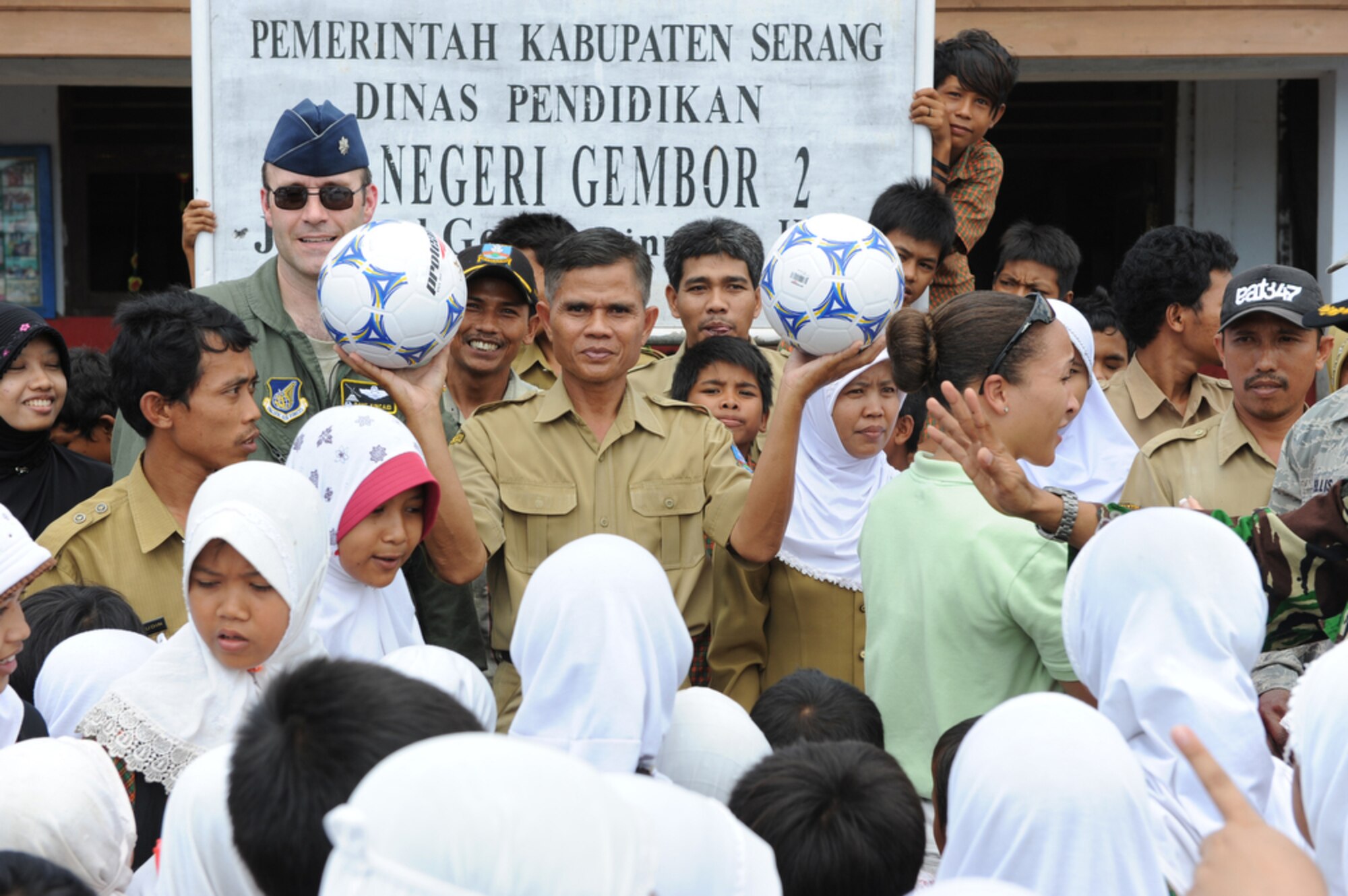 Lt. Col. Dave Kincaid joins the Sd Negeri Gembor 2 Elementary School headmaster April 21 during a community relations event in the Lanud Gorda Binuang area of Indonesia.  Colonel Kincaid, 36th Airlift Squadron commander at Yokota Air Base, Japan, and other Yokota personnel delivered more than 1,200 pounds of clothes, toys and sports equipment to the school. Yokota Airmen are participating in Cope West 10, a Pacific Air Forces-sponsored bilateral tactical airlift exercise involving the U.S. and Indonesian air forces. The exercise is designed to advance interoperability between the two services, and promote cooperation and unity of purpose. (U.S. Air Force photo/Tech Sgt. Cohen A. Young)