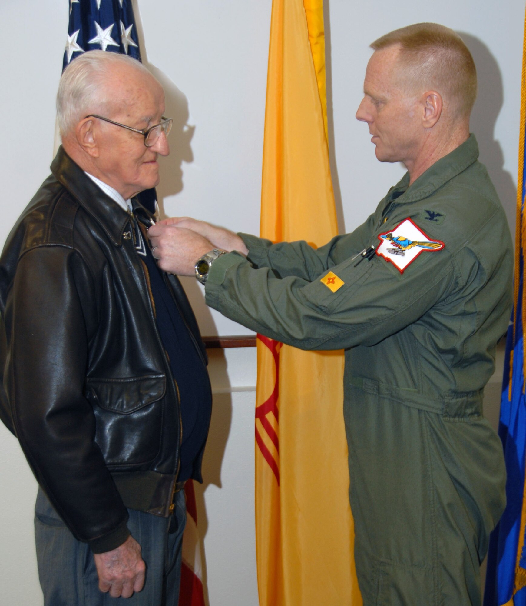 In an April 6 ceremony, World War II veteran 2nd Lt. Robert L. Giles received the Air Medal from Col. Fred Hartwig, 150th Fighter Wing commander. U.S. Air Force Photo by Master Sgt. Paula Y. Aragon 