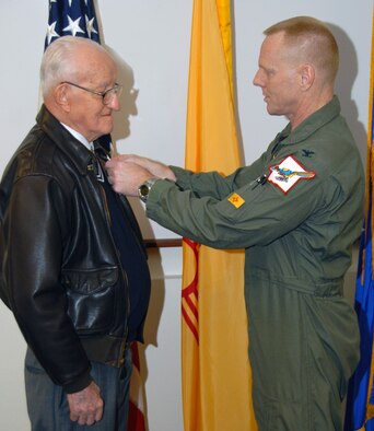 In an April 6 ceremony, World War II veteran 2nd Lt. Robert L. Giles received the Air Medal from Col. Fred Hartwig, 150th Fighter Wing commander. U.S. Air Force Photo by Master Sgt. Paula Y. Aragon 