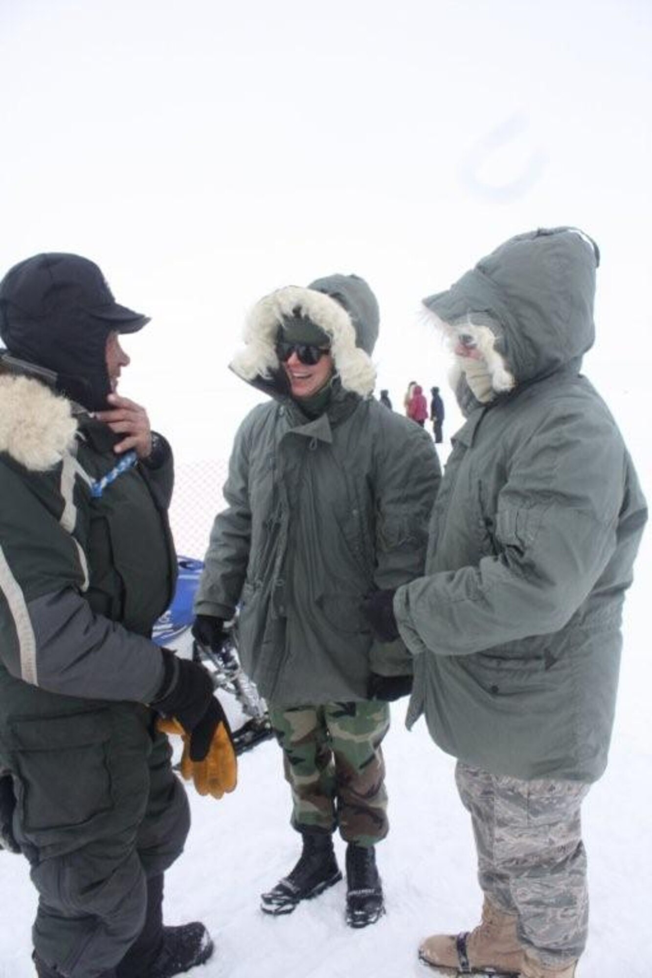 Lt. Col. Frances McClure, a dentist with the 916th AMDF and Senior Airman Samantha Crawford, from Lackland Air Force Base, Texas, talk with an Iditarod musher during Artic Care 2010. (USAF photo courtesy of 916 AMDF)