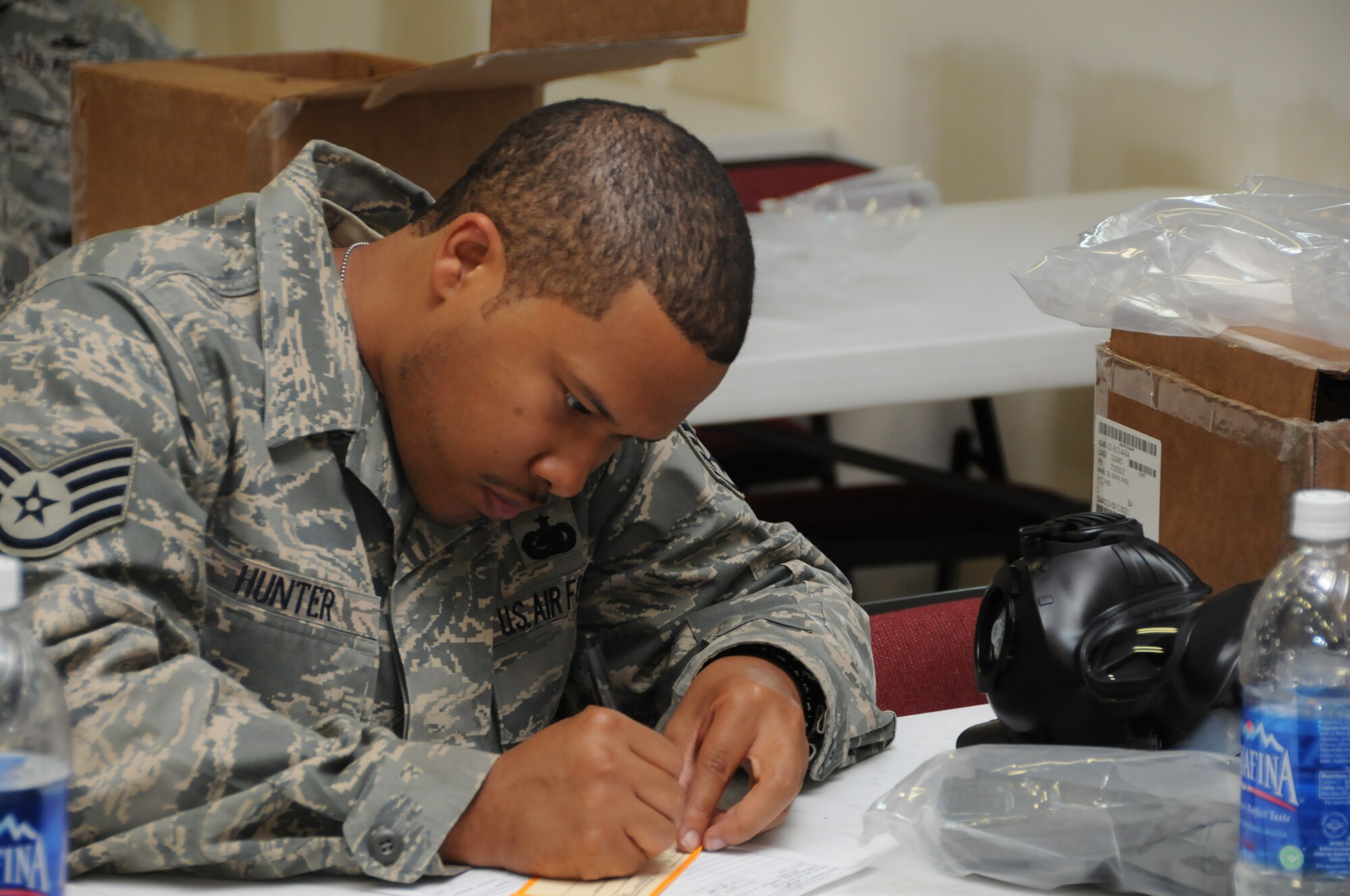 Staff Sgt. Christopher Hunter, Reservist with the 916th Logistics Readiness Squadron, fills in his gas mask inspection form. New masks are being issued throughout the wing. (USAF photo by TSgt. Scotty Sweatt, 916ARW/PA)