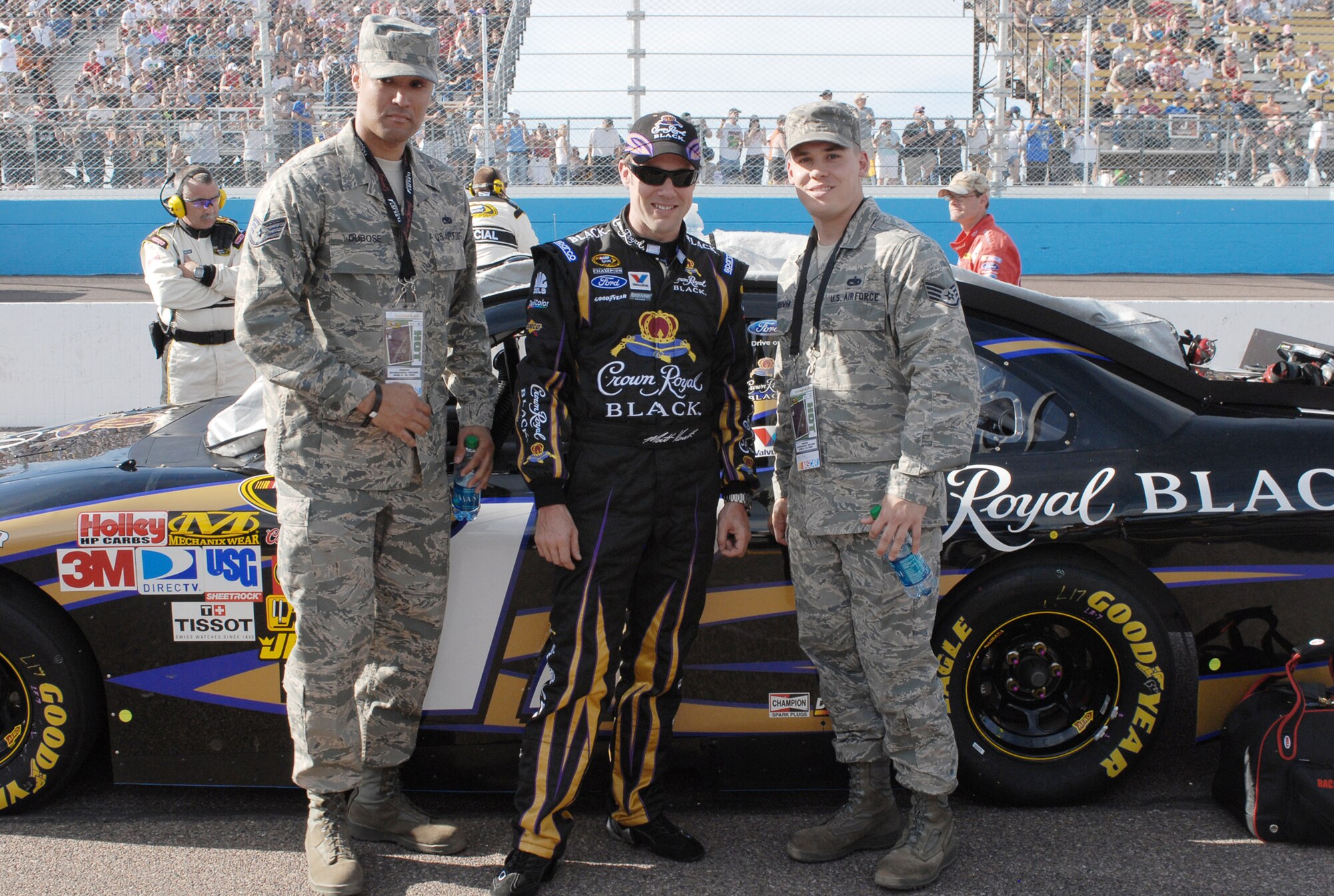 Staff Sgts. Damon Thurman (right) and Charlton Dubose  pose with NASCAR driver Matt Kenseth April 10, 2010, during the Subway Fresh Fit 600 NASCAR race at the Phoenix International Raceway. Sergeants Thurman and Dubose are 56th Maintenance Group quality assurance inspectors. (U.S. Air Force photo/Airman 1st Class Sandra Welch)