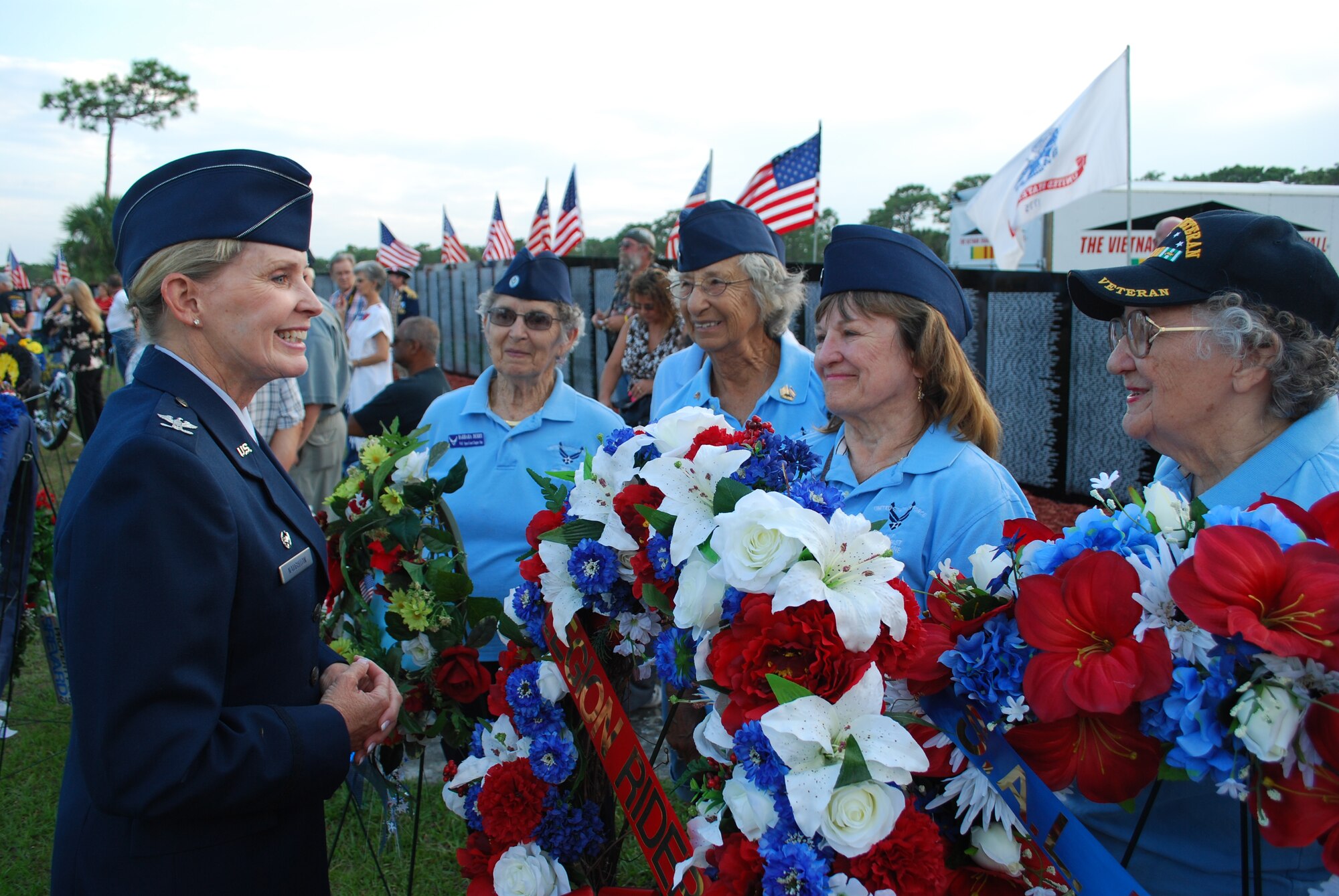 Col. Corinne Naughton, left, commander, 45th Medical Group, shares a smile with members of the “Woman’s Air Force, Space Coast Chapter One” during the opening of the Vietnam Veterans Reunion held at Wickham Park in Melbourne, Fla., April 19. Col. Naughton represented the 45th Space Wing at the 23rd edition of the event. In all, 84 wreaths were laid in front of the Vietnam Traveling Memorial Wall by various organizations. (U.S. Air Force photo/Christopher Calkins)