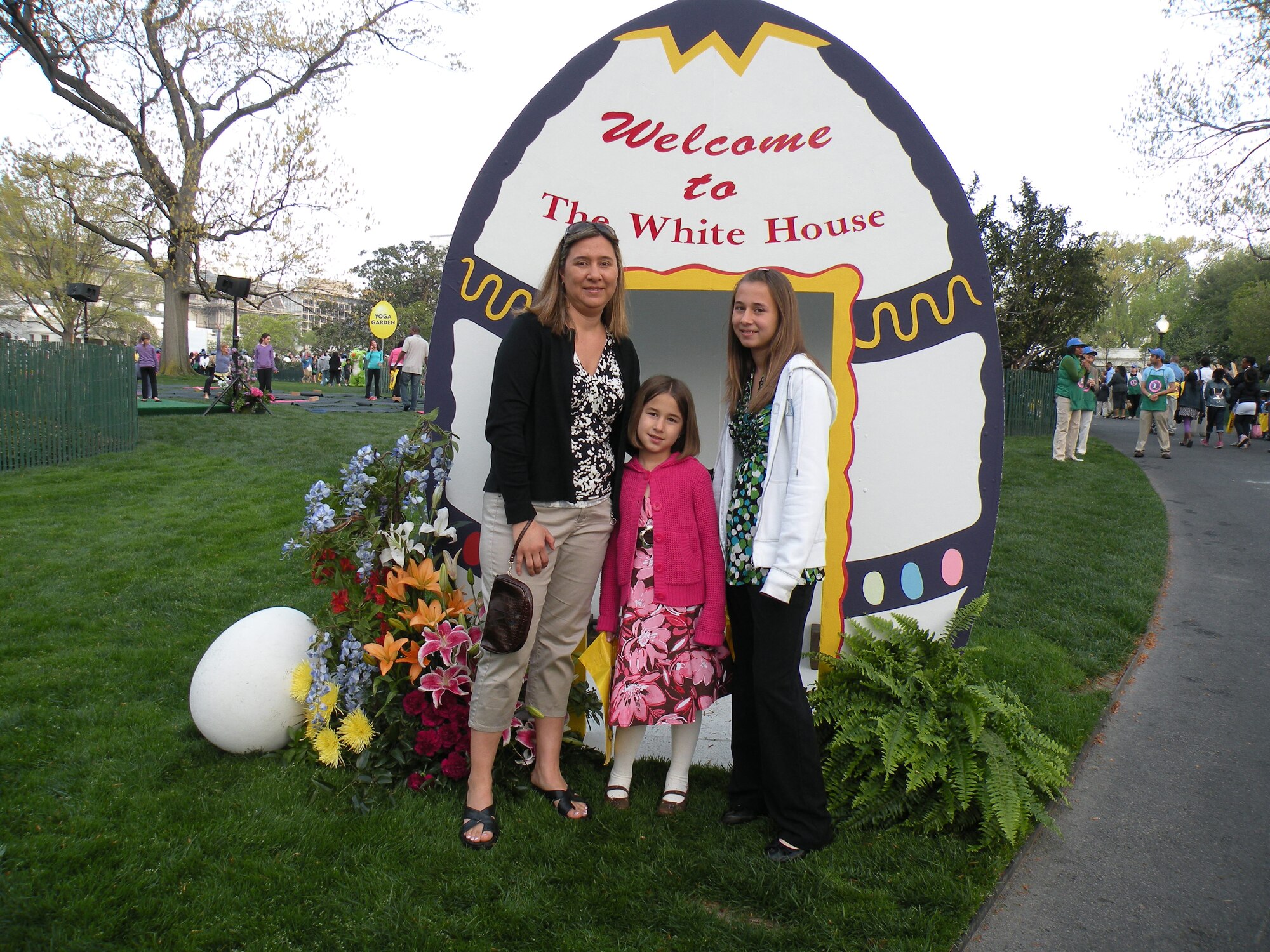 Regina Watson, wife of Master Sgt. Michael Watson, 436th Operations Support Squadron, stand in front of a decorative Easter Egg sign with her daughters (center) Carlee and (right) Baylee during the 2010 White House Easter Egg Roll April 5.  (U.S. Air Force courtesy photo)