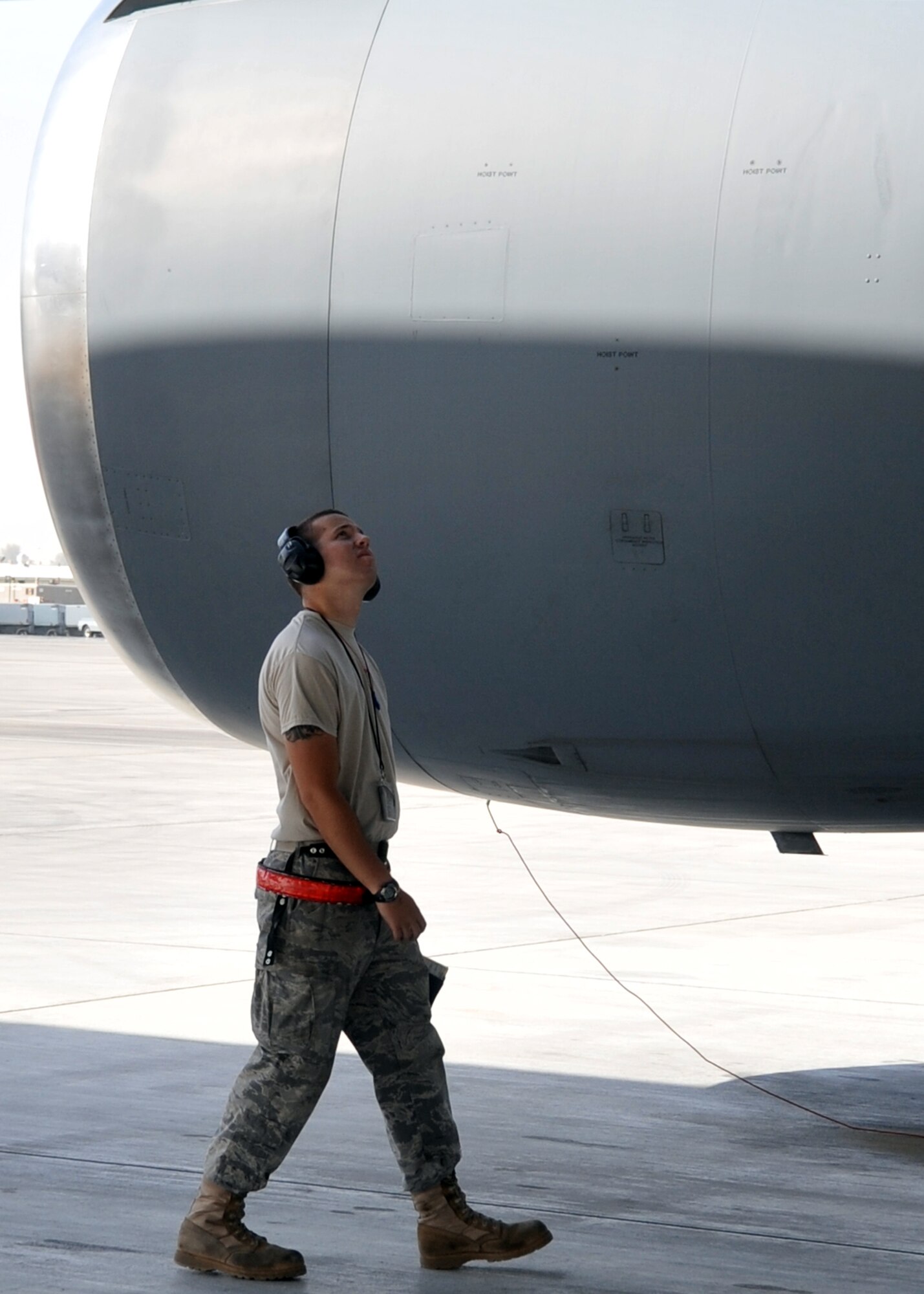 Staff Sgt. Nicholas Shoenhair, KC-10 Extender crew chief with the 380th Expeditionary Aircraft Maintenance Squadron Extender aircraft maintenance unit, looks over the engine of the KC-10 during operations on the flightline for the 380th Air Expeditionary Wing at a non-disclosed base in Southwest Asia. Sergeant Shoenhair is deployed from the 660th Aircraft Maintenance Squadron at Travis Air Force Base, Calif., and his hometown is Fort Meyers, Fla. (U.S. Air Force Photo/Master Sgt. Scott T. Sturkol/Released)