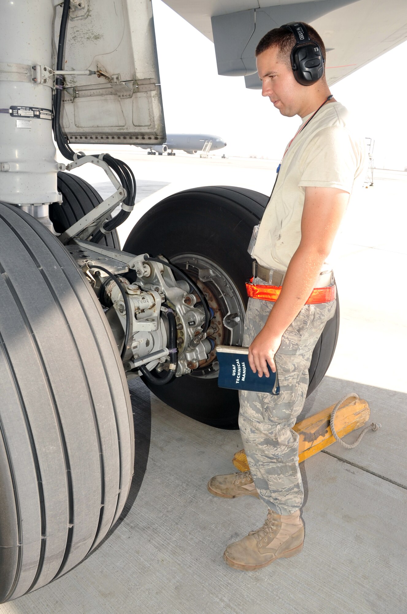 Staff Sgt. Nicholas Shoenhair, KC-10 Extender crew chief with the 380th Expeditionary Aircraft Maintenance Squadron Extender aircraft maintenance unit, looks over landing gear of the KC-10 he's assigned to during operations on the flightline for the 380th Air Expeditionary Wing at a non-disclosed base in Southwest Asia. Sergeant Shoenhair is deployed from the 660th Aircraft Maintenance Squadron at Travis Air Force Base, Calif., and his hometown is Fort Meyers, Fla. (U.S. Air Force Photo/Master Sgt. Scott T. Sturkol/Released)