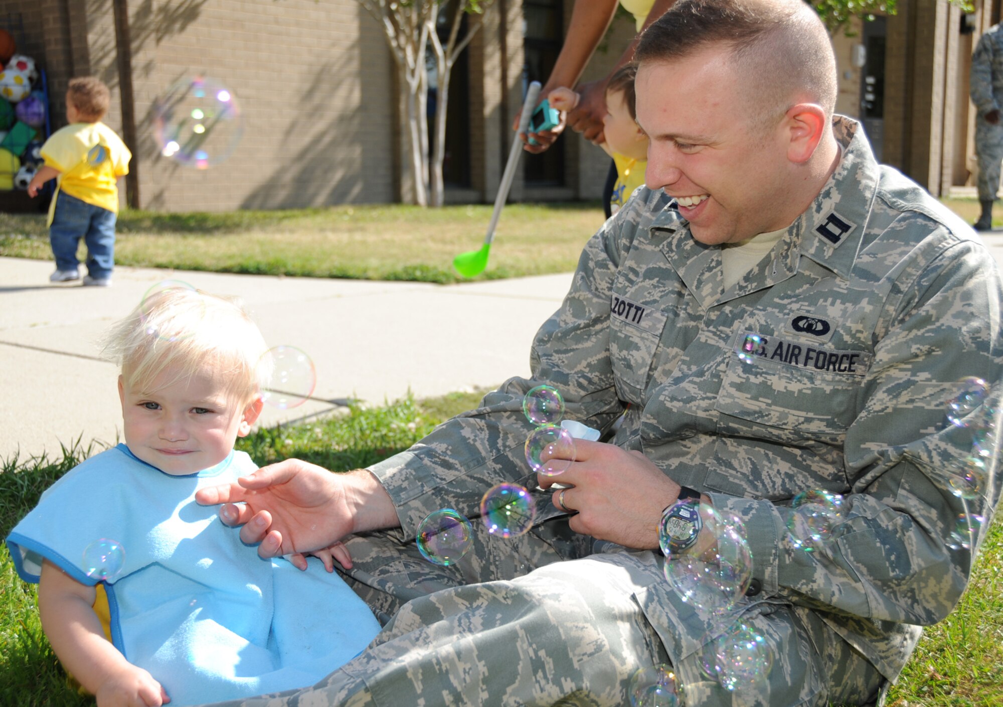 One-year-old Luke Balzotti watches the bubbles being blown by his dad, Capt. Michael Balzotti, 334th TRS.  Luke’s mom, Courtney, works in the 81st DS.  (U.S. Air Force photo by Kemberly Groue)