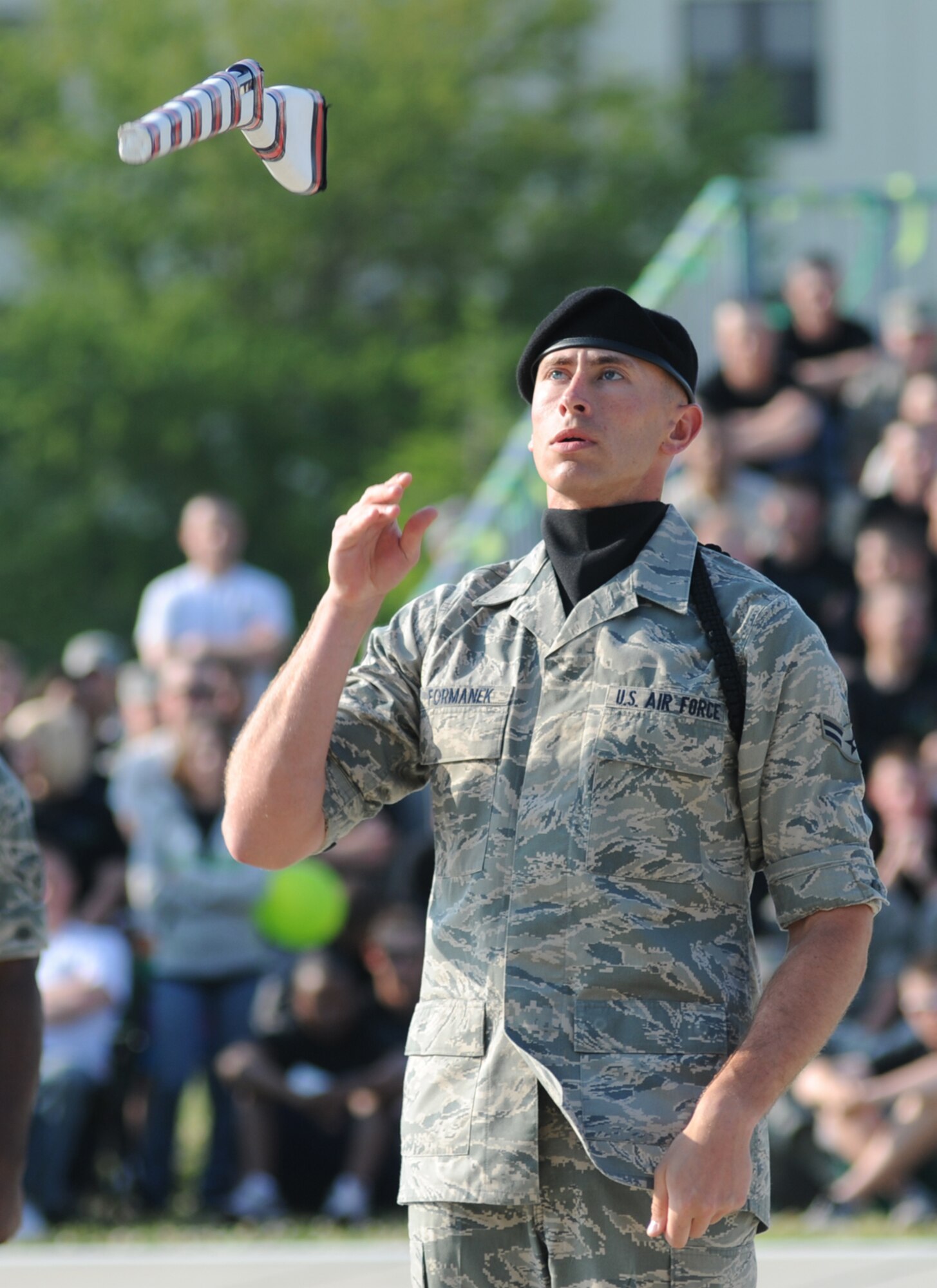 Airman 1st Class Joshua Formanek, 336th TRS drill master, tosses his rifle during the freestyle competition.  The Red Wolves came in third place overall.  (U.S. Air Force photo by Kemberly Groue)