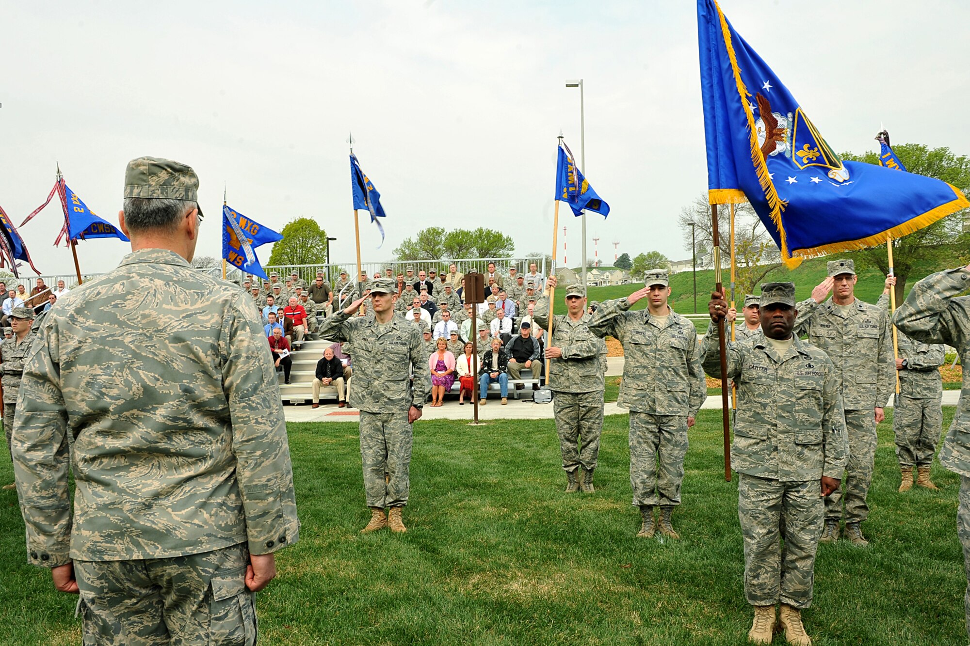 OFFUTT AIR FORCE BASE, Neb. -- Members of the Air Force Weather Agency salute Col. John D. Murphy, outgoing AFWA commander, during a change of command ceremony here April 20 in front of the Lt. Gen. Thomas S. Moorman Building. The agency is comprised of more than 1,400 active-duty members, civil service employees and contractors at 14 operating locations around the world which provide centralized weather products and services, including climatological and space weather support to all branches of the armed forces. U.S. Air Force photo by Charles Haymond