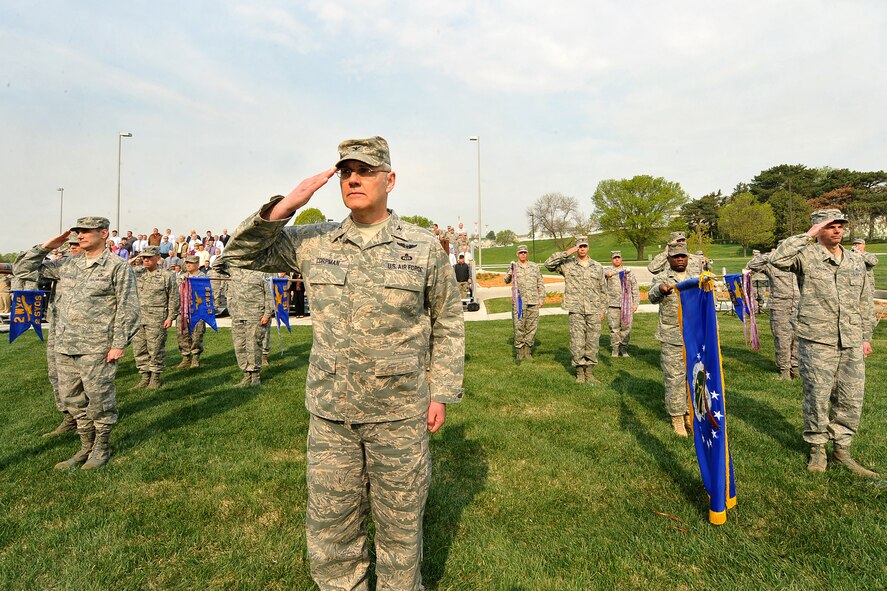 OFFUTT AIR FORCE BASE, Neb. -- Members from the Air Force Weather Agency salute the U.S. flag during the AFWA change of command ceremony here April 20 in front of the Lt. Gen. Thomas S. Moorman building. The agency is comprised of more than 1,400 active-duty members, civil service employees and contractors at 14 operating locations around the world which provide centralized weather products and services, including climatological and space weather support to all branches of the armed forces. U.S. Air Force photo by Charles Haymond