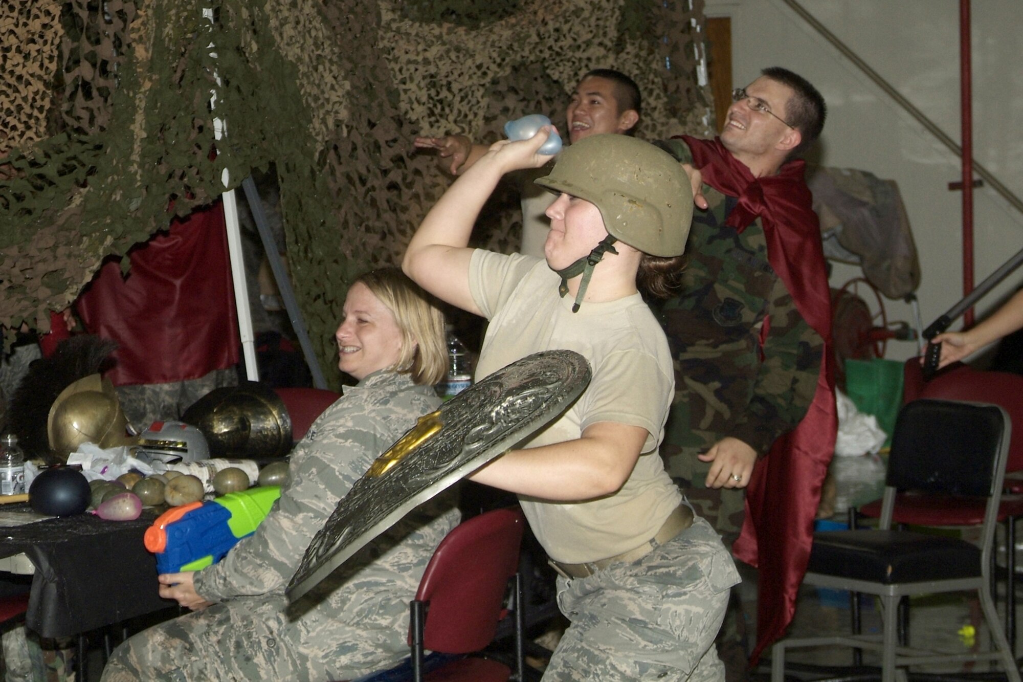 Airman 1st Class Ashley Jordan, foreground, and Senior Airman Bradley Louk and Airman 1st Class Harold Tamondong toss water balloons as Lt. Col. (Dr.) Lynn Berry watches.  They are assigned to the 81st Aerospace Medicine Squadron.  (U.S. Air Force photo by Herb Welch)