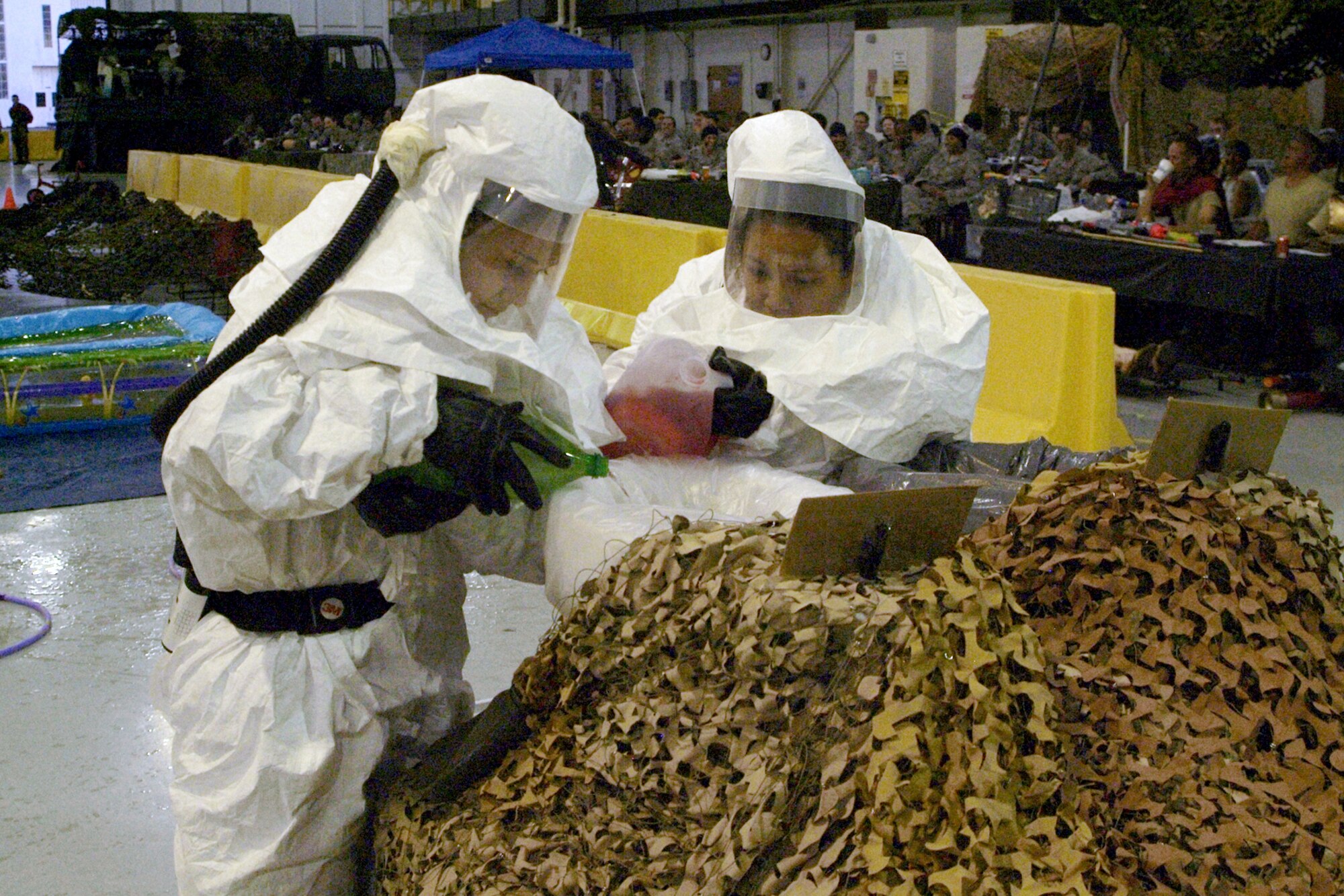 Airman 1st Class Ashley Jordan, left, and Senior Airman Sheila DeL’etoile, 81st Aerospace Medicine Squadron bioenvironmental flight, pour the squadron’s “contribution” to the grog bowl as the dining in gets underway.  (U.S. Air Force photo by Herb Welch)