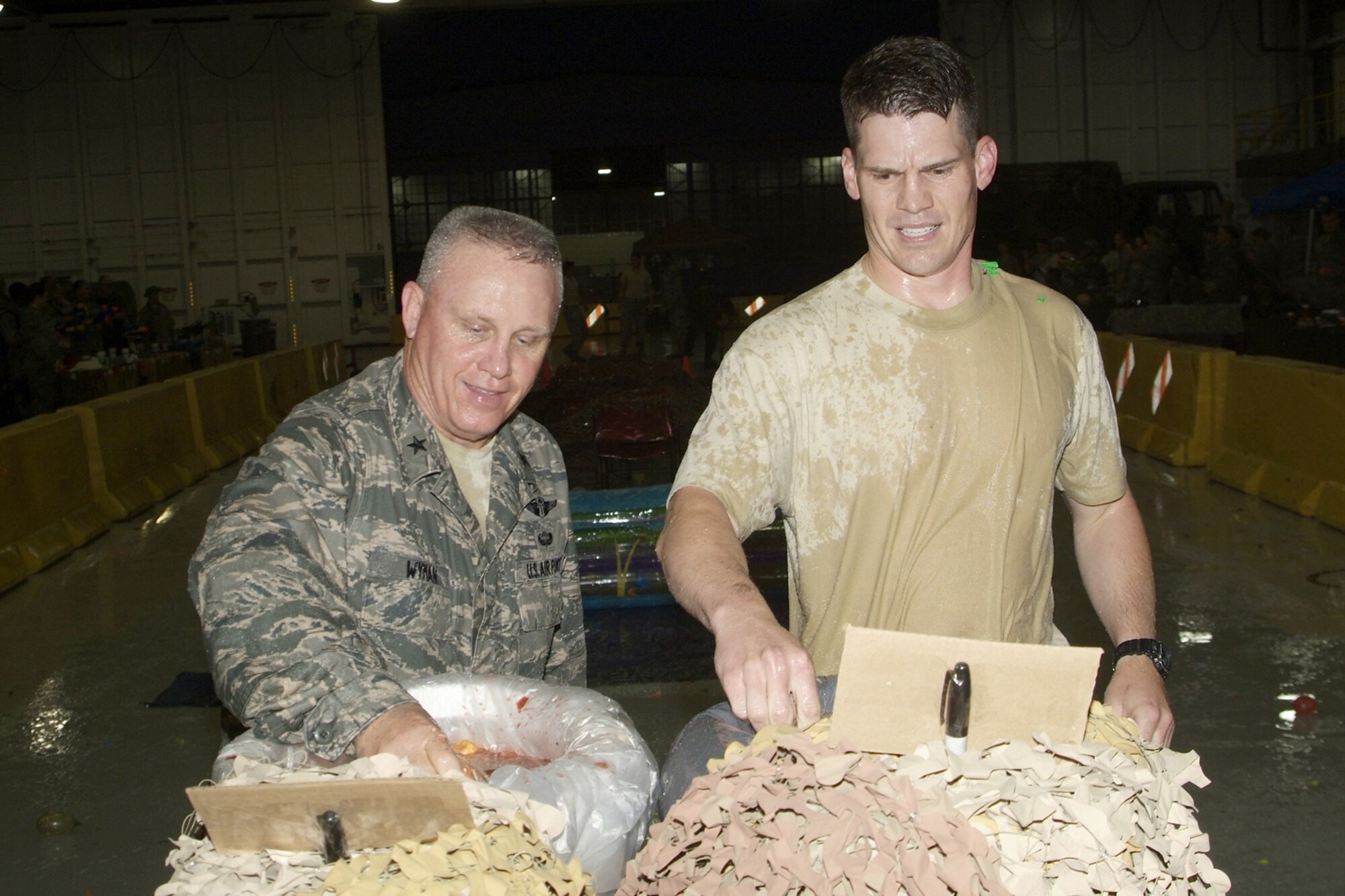 Brig. Gen. (Dr.) Dan Wyman, left, 81st Medical Group commander, and 1st Lt. Zane Holland, 81st Medical Support Squadron, dip into the grog bowl after being sent to the brew for infractions of the Rules of the Mess.  Lieutenant Holland was “Mr. Vice” during Friday’s 81st Medical Group combat dining-in.  (U.S. Air Force photo by Herb Welch)