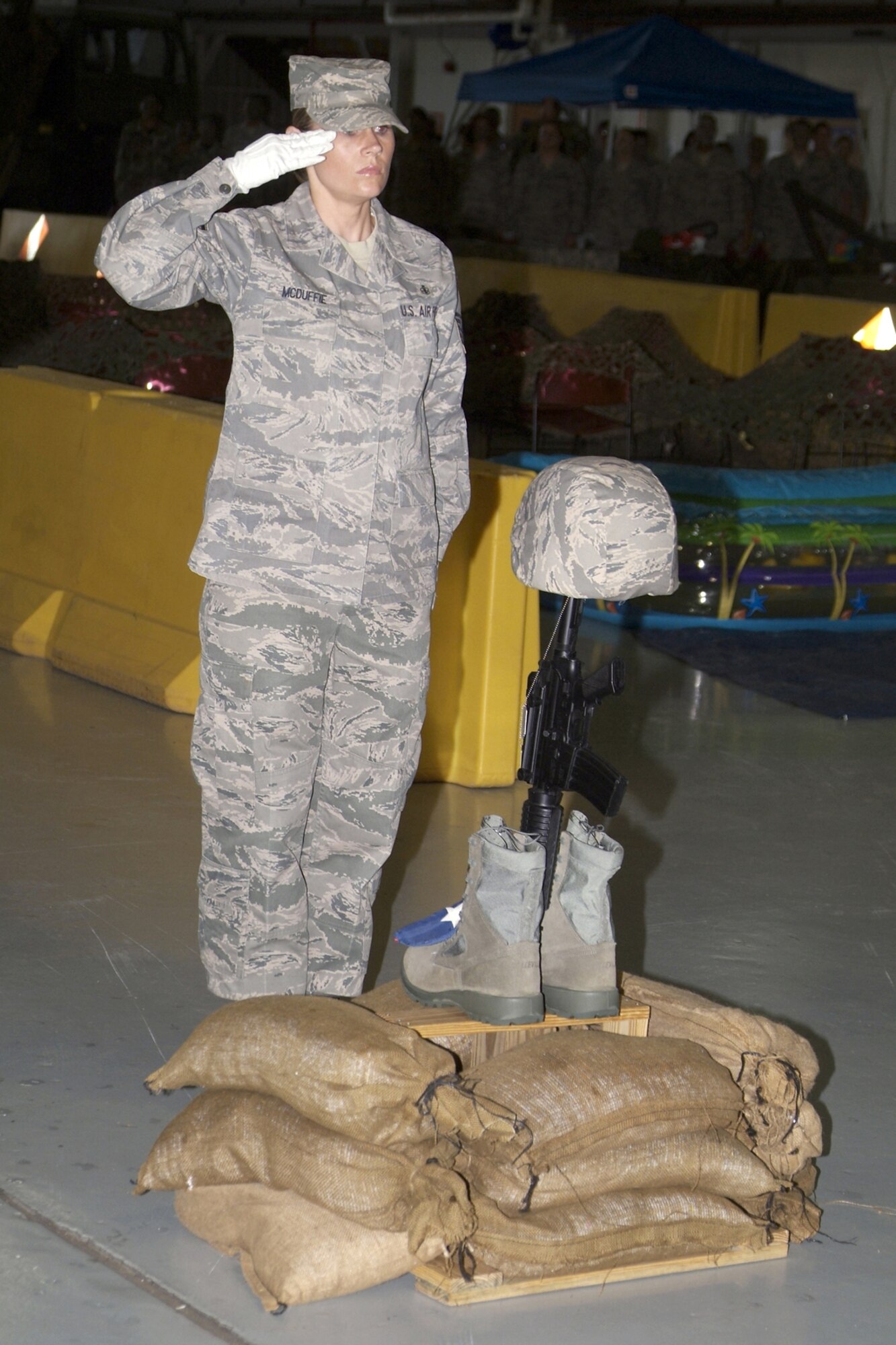 Master Sgt. Jaycey McDuffie, 81st Diagnostics and Therapeutics Squadron, renders a salute after placing the American flag on the “Fallen Heroes” display during the formal portion of the event.    (U.S. Air Force photo by Herb Welch)