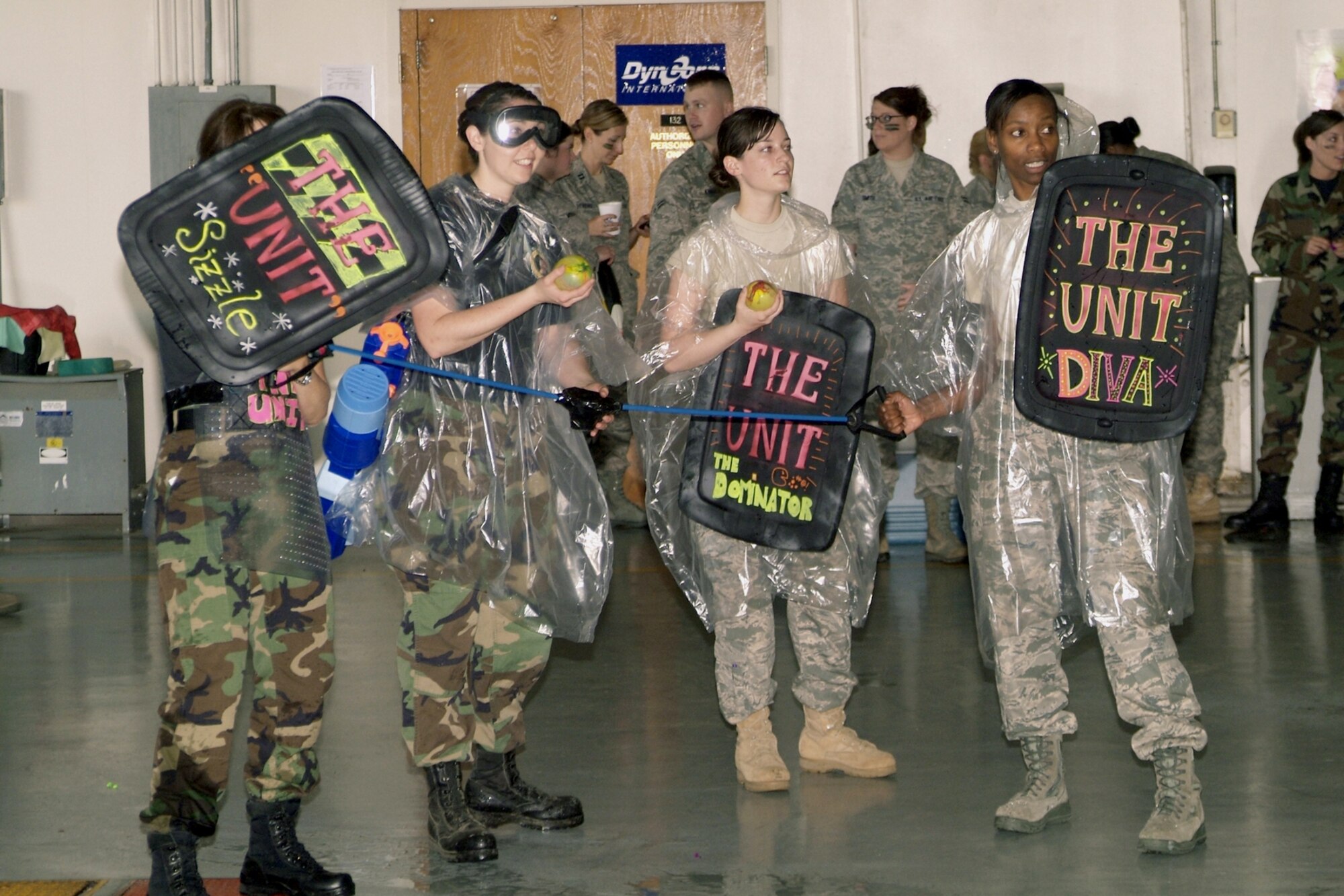 From left, Capt. Pamela Frabe, 1st Lt. Joanna Cooley, Senior Airman Marlena Pagliuca and 1st Lt Jacquelyn Smith, members of  “The Unit,” actually the 81st Inpatient Operations Squadron critical care unit, prepare to launch a water balloon attack during the dining-in.    (U.S. Air Force photo by Herb Welch)