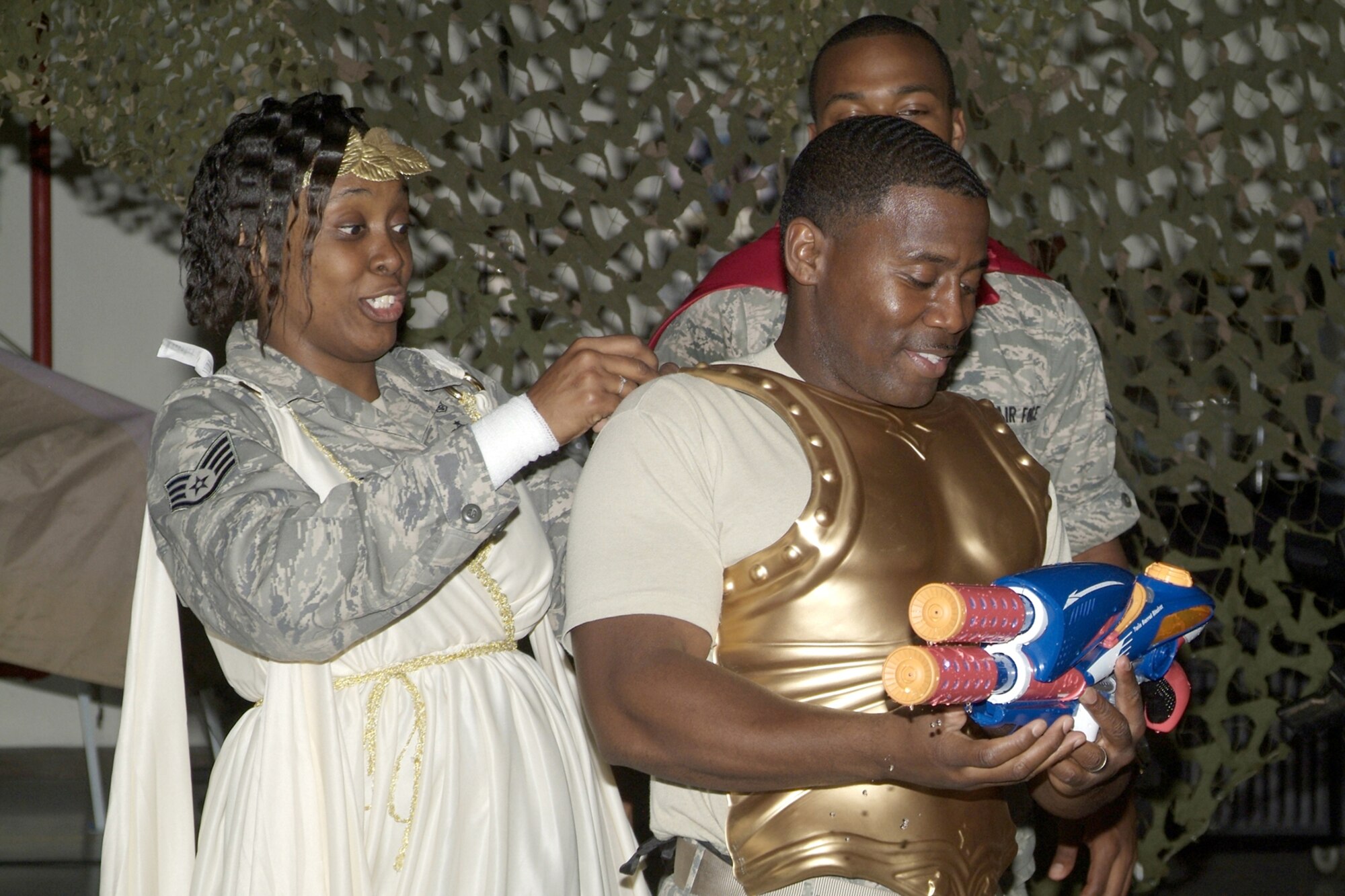 Staff Sgt. Starr Haywood, 81st Aerospace Medicine Squadron, helps her first sergeant, Master Sgt. Lee Utsey, “suit up” for the start of the dining-in.  Sergeant Haywood served as “Madam Vice” for the event.  (U.S. Air Force photo by Herb Welch)