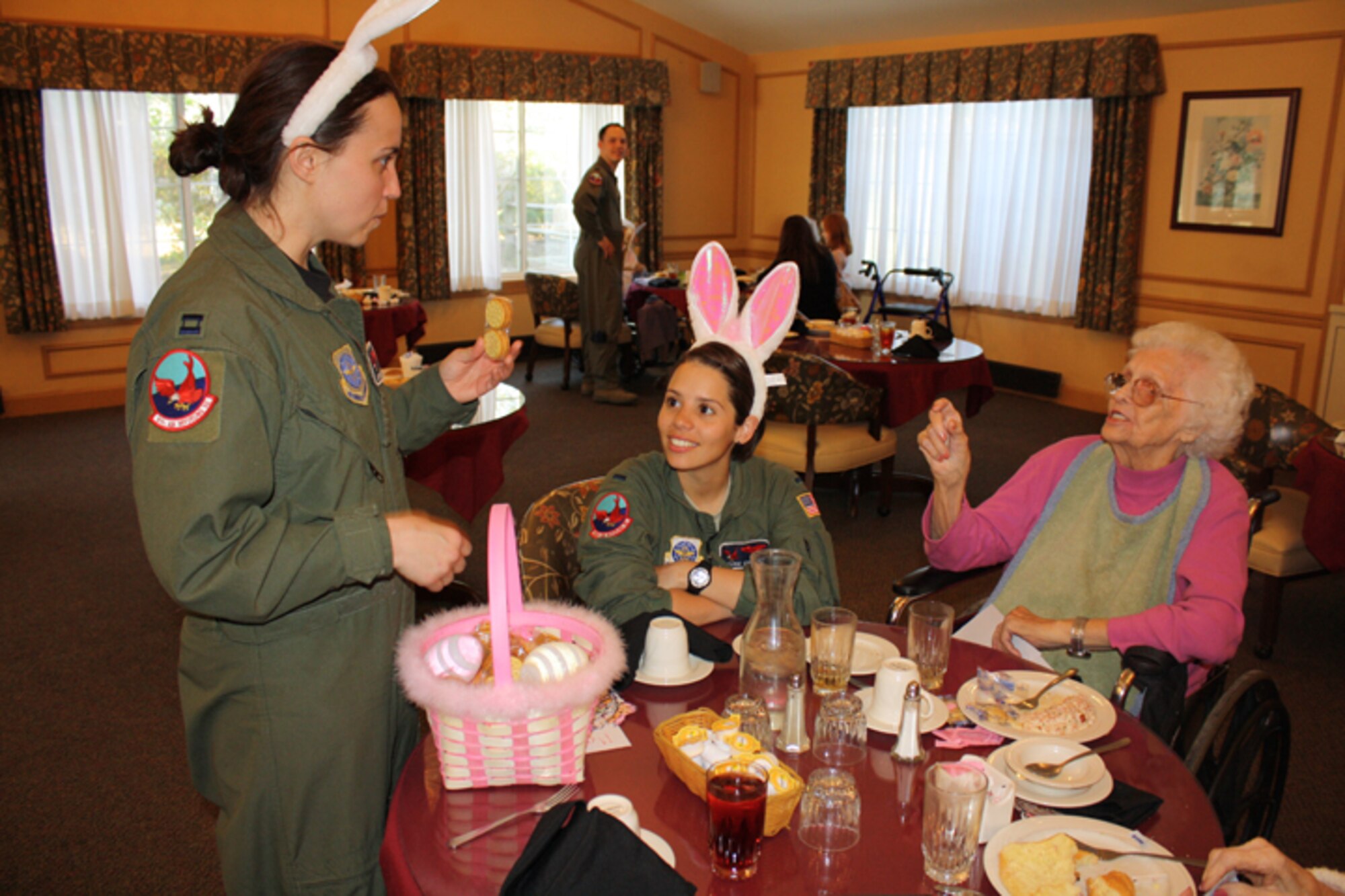 Capt. Jessica Guarini (left), Capt. Aaron Marx (background) and 1st Lt. Suzanne Crespo, members of the Wright Brothers Airlift Tanker Association, give back to the community in April when they visited The Pines in Goldsboro. (USAF photo courtesy of the 911ARS)