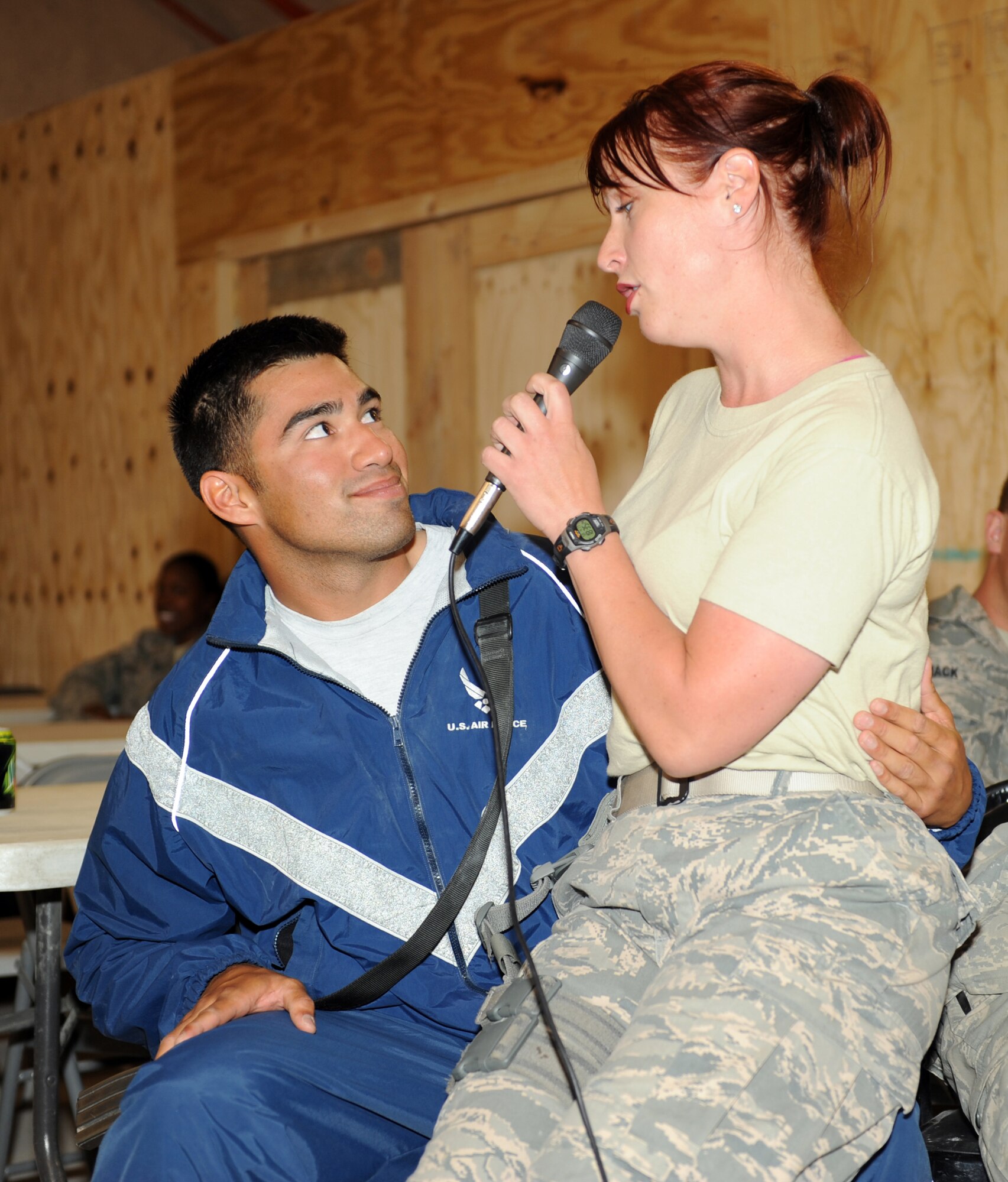 Airman 1st Class Jill Diem, vocalist, U.S. Air Forces Central Band Reserve Generation, serenades Senior Airman Luis Murillo, 455th Expeditionary Civil Engineers Squadron Force Protection Flight, during a concert at Bagram Airfield, Afghanistan, April 17, 2010. Airman Murillo is deployed from Kadena Air Base, Japan. The band is completing a two-month tour of Southwest Asia and is deployed from Robins Air Force Base, Ga.  (U.S. Air Force photo by/ Staff Sgt. Richard Williams)