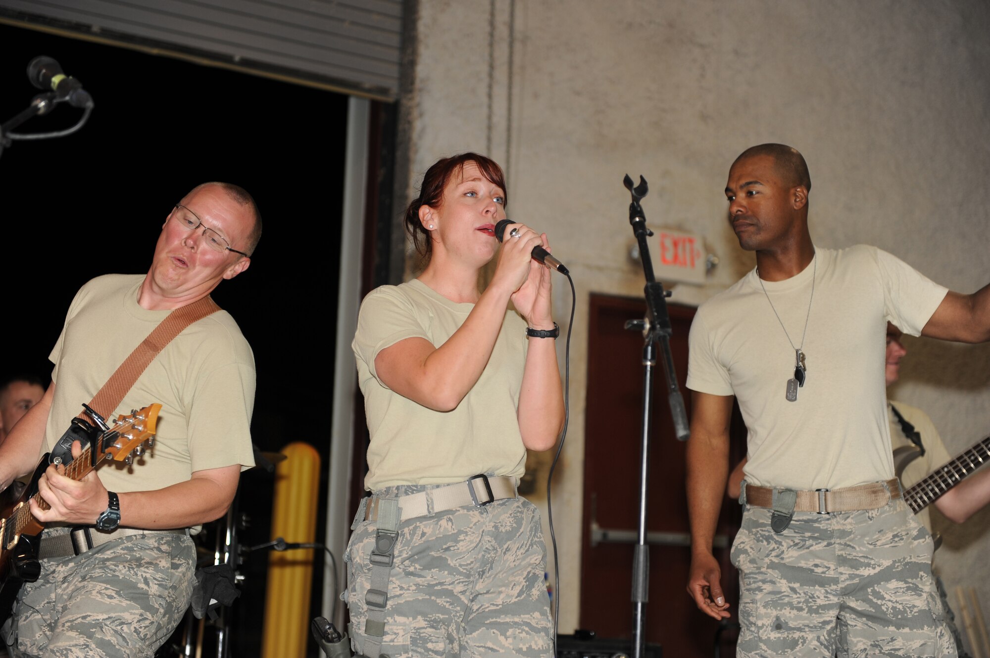 U.S. Air Force Senior Airman Josh Byrd, guitarist (left), Airman 1st Class Jill Diem, vocalist, and Master Sgt. Aaron Miles, non-commissioned officer in charge of U.S. Air Forces Central Band Reserve Generation, perform at Bagram Airfield, Afghanistan, April 17, 2010. The band is completing a two-month tour of Southwest Asia and is deployed from Robins Air Force Base, Ga. (U.S. Air Force photo by/ Staff Sgt. Richard Williams)