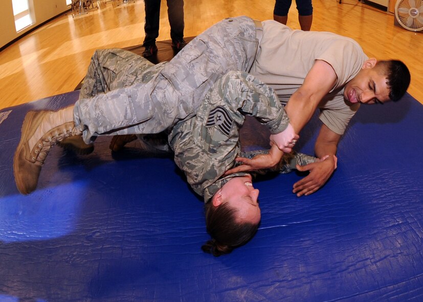 MINOT AIR FORCE BASE, N.D. – Tech. Sgt. Georgette Dieckman, 5th Force Support Squadron noncommissioned officer -in -charge of fitness center operations, uses a hip thrust to defend against “simulated attacker” Staff Sgt. Esteban Rivera, 5th Maintenance Squadron Aerospace Ground Equipment journeyman, during a self defense class at the McAdoo Sports and Fitness Center on Minot AFB April 7. The class was taught by Roger Martin, Shun –Shifu (head school instructor), owner of a local karate club in Minot, ND. (U.S. Air Force photo by Senior Airman Sharida Jackson)