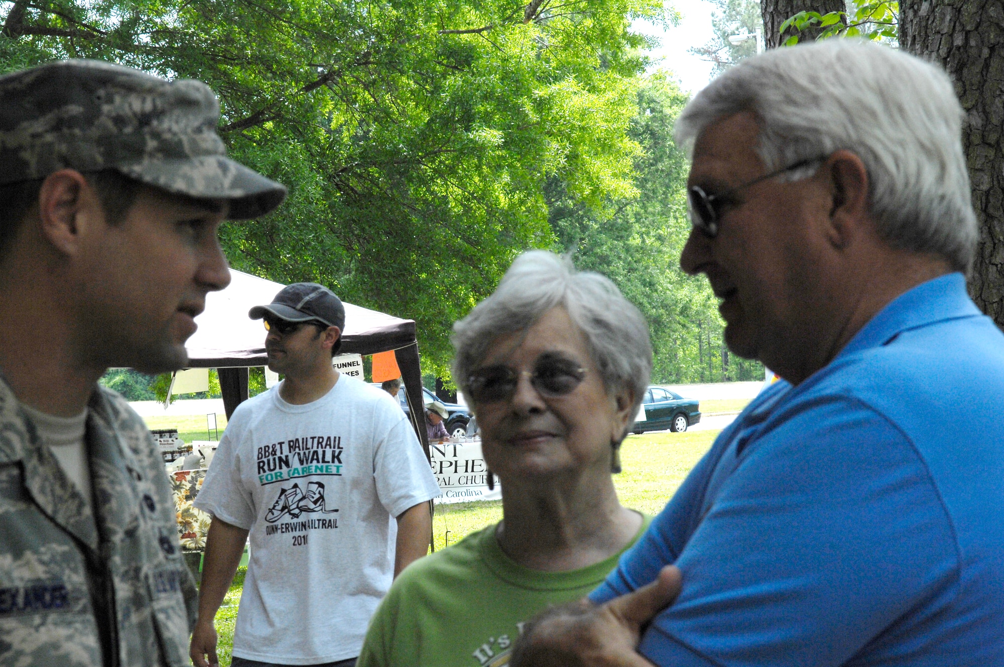 Master Sgt. Chris Alexander, 3rd Aerial Port Squadron, speaks with Erwin Mayor, Patsy Carson, and Joe Tart, 21st Special Tactics Squadron Honorary Commander, during the Earth Day Celebration in Erwin, N.C. on April 17. Earth Day is an annual event, which promotes the sustainment of the Earth’s environment. (U.S. Air Force Photo/Vicki Johnson)
